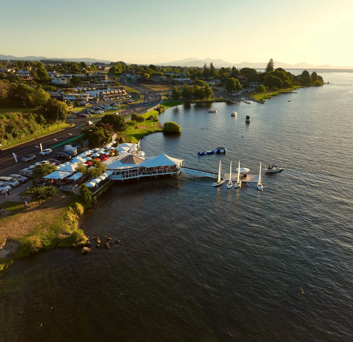 Our Pillar - the Two Mile Bay Sailing Club

Set on the lakefront, @2miletaupo is where everything begins and where it keeps coming back to.

It transforms into our start line and transition, with fuel and hydration, warm-up and recovery zones, and li