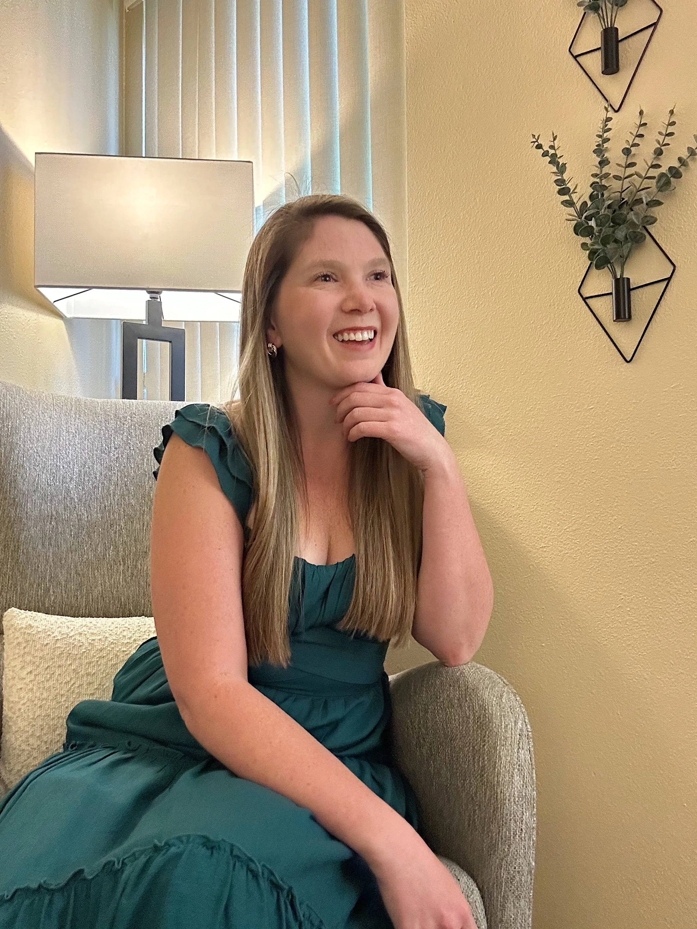 anxiety therapist on a chair talking and smiling with client, relationship therapist achieving goals with a client