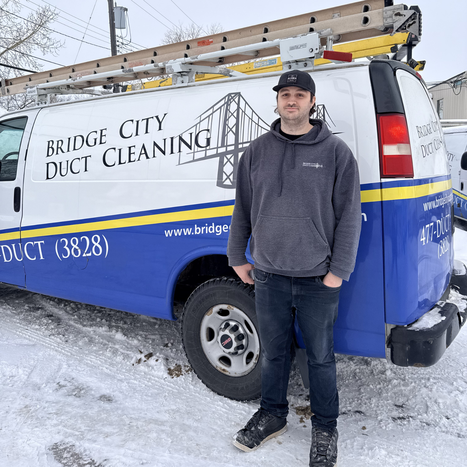 Austin smiling in front of Bridge City Van