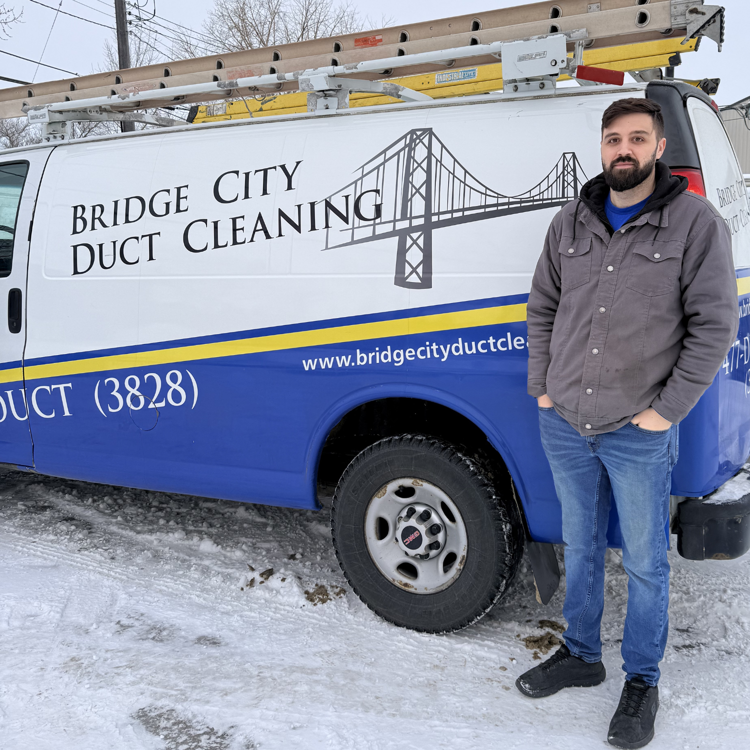Brayden smiling in front of Bridge City Van