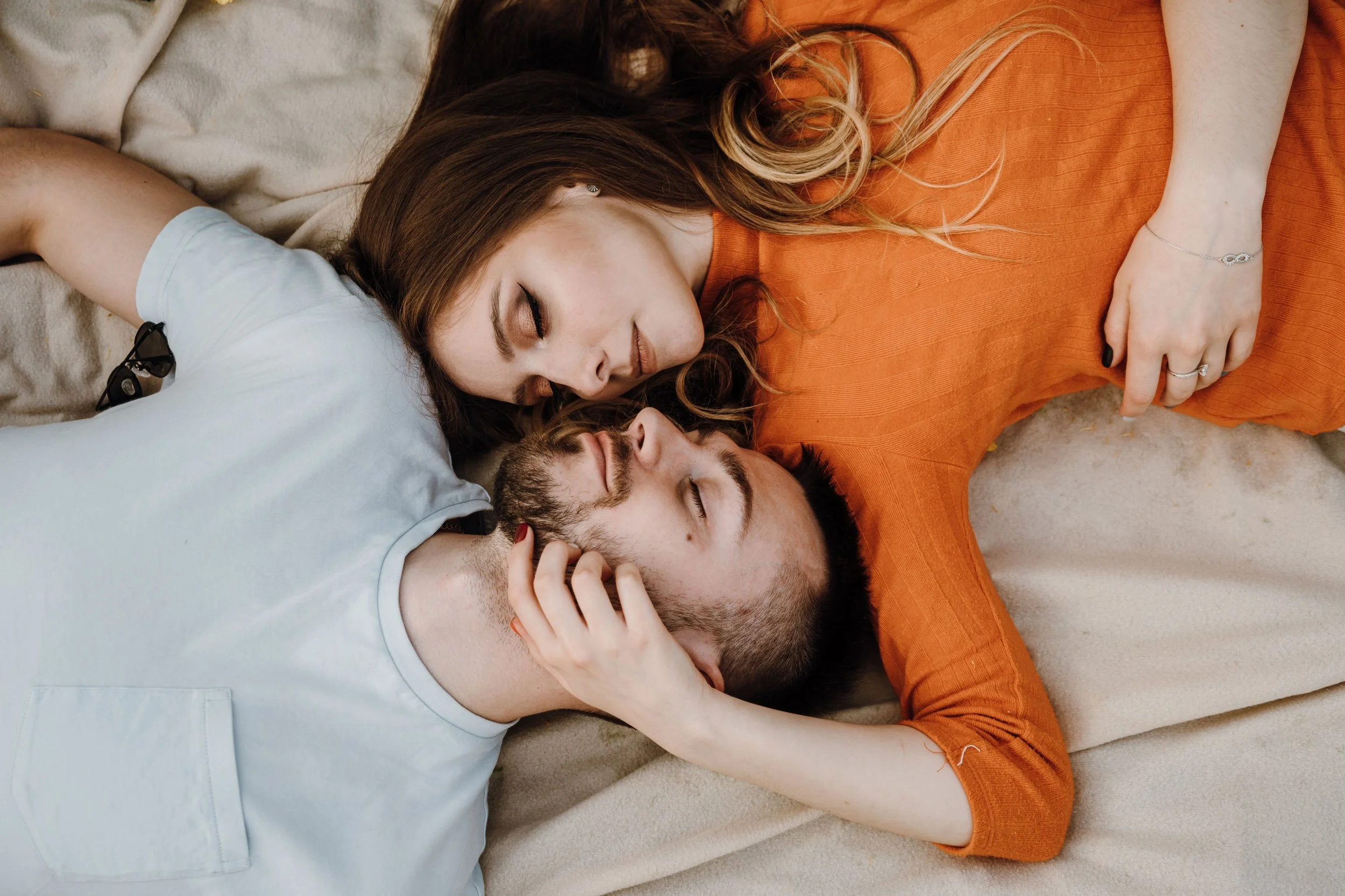 Couple sleeping on the sand.