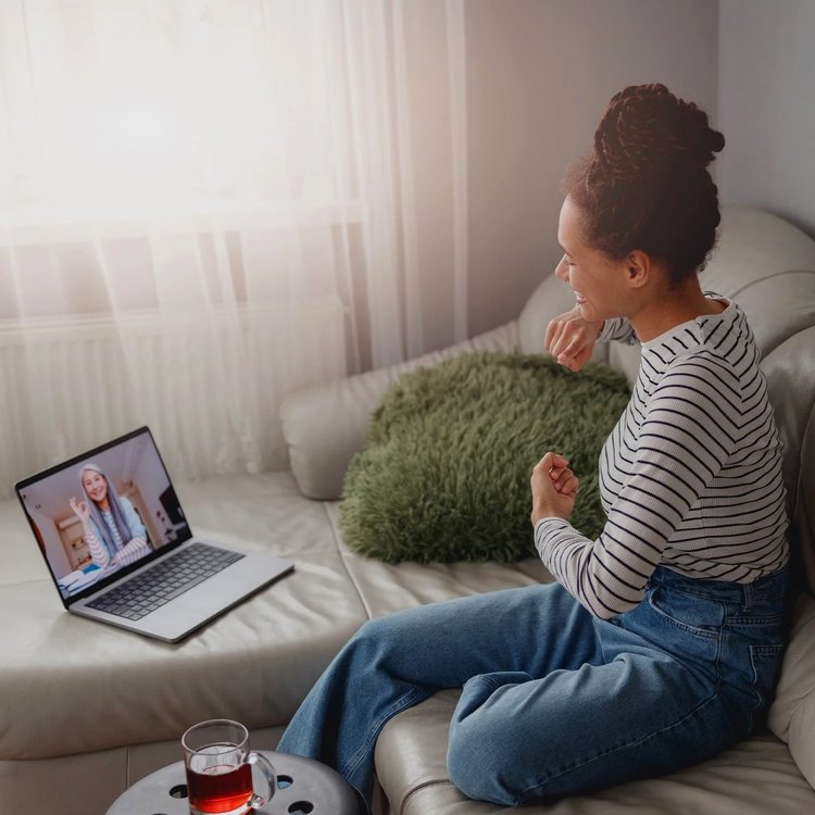 Woman sitting on sofa look at tablet