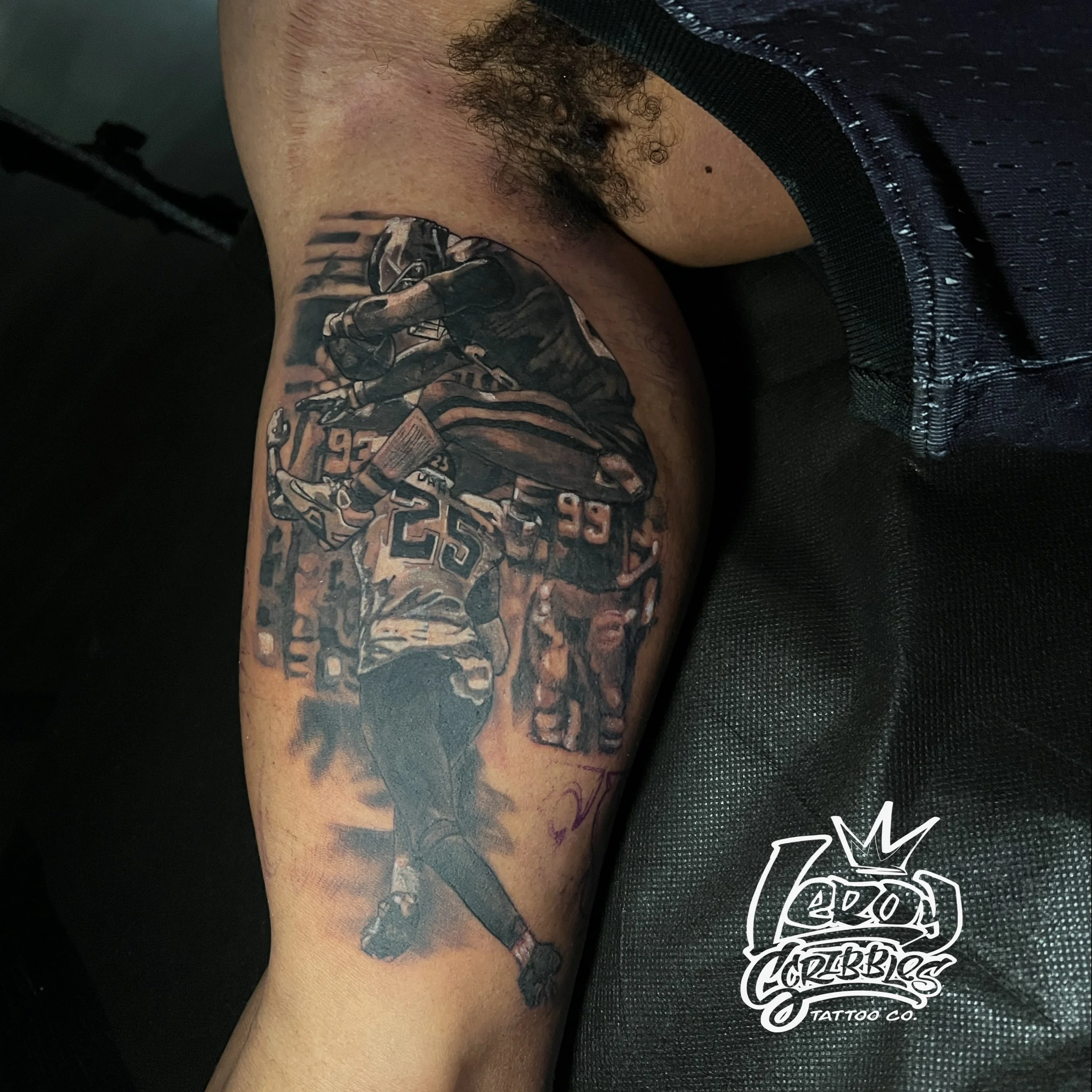 Black and grey photo realism sports action shot of Philadelphia eagles star running back Saquon Barkley reverse hurdling Jacksonville jaguars cornerback Jarrin Jones. This tattoo was done by Leroy scribbles an Arizona tattoo artist located in Mesa Ar