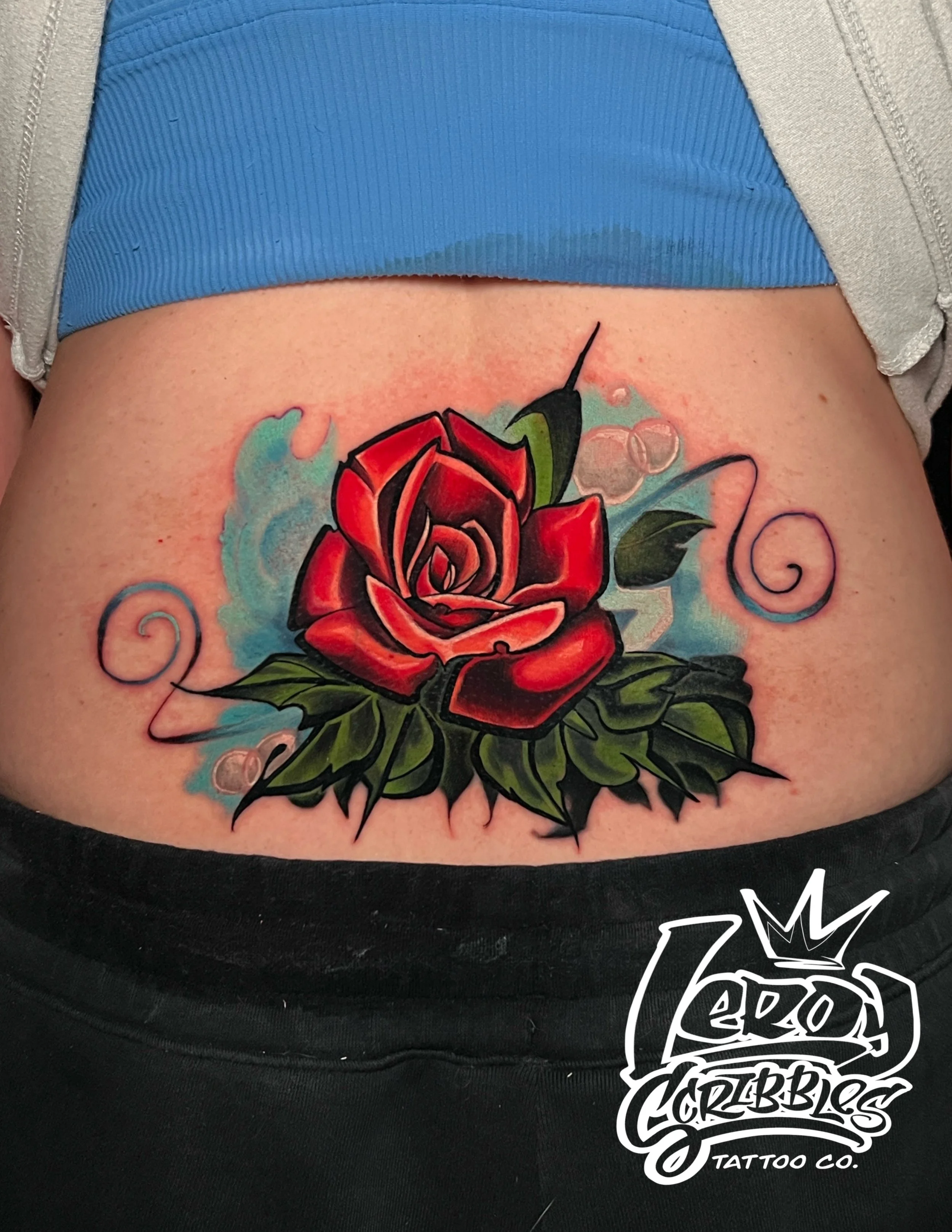 Leroy Scribbles original red rose cover up on woman’s lower back “ tramp stamp cover up” done by Leroy Scribbles an Arizona local tattoo artist