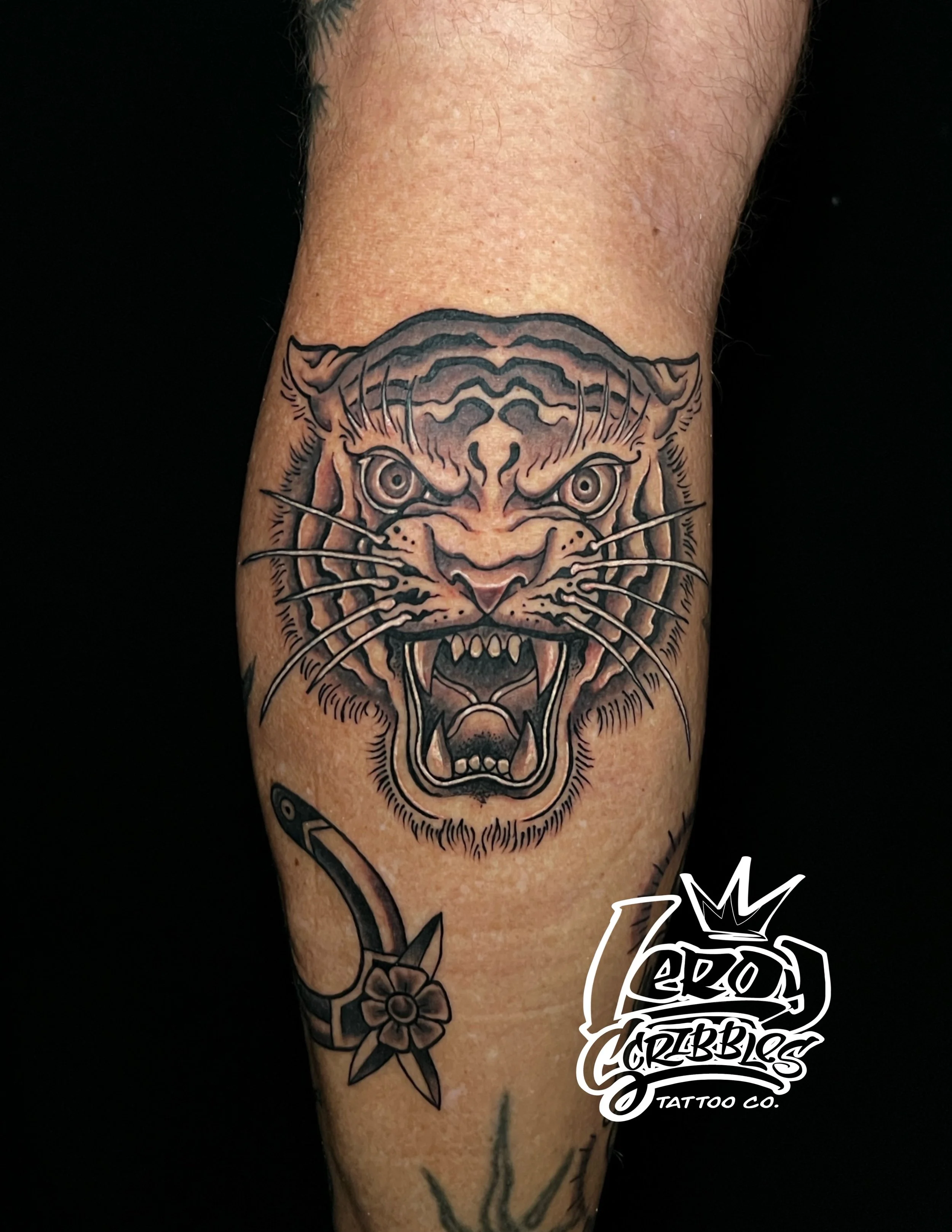 American traditional tiger head on man’s calf done by Leroy Scribbles