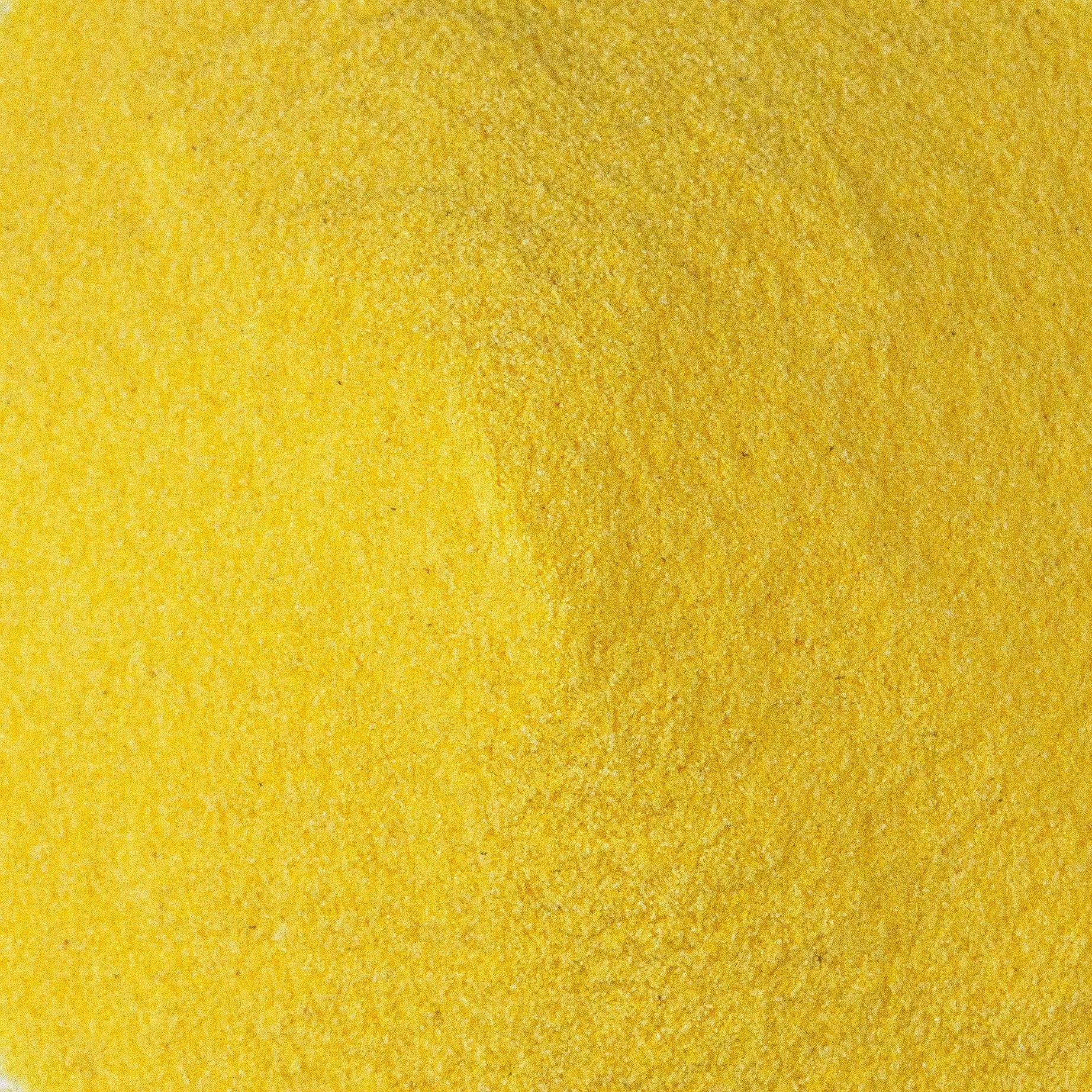 Close-up of a yellow, textured surface.