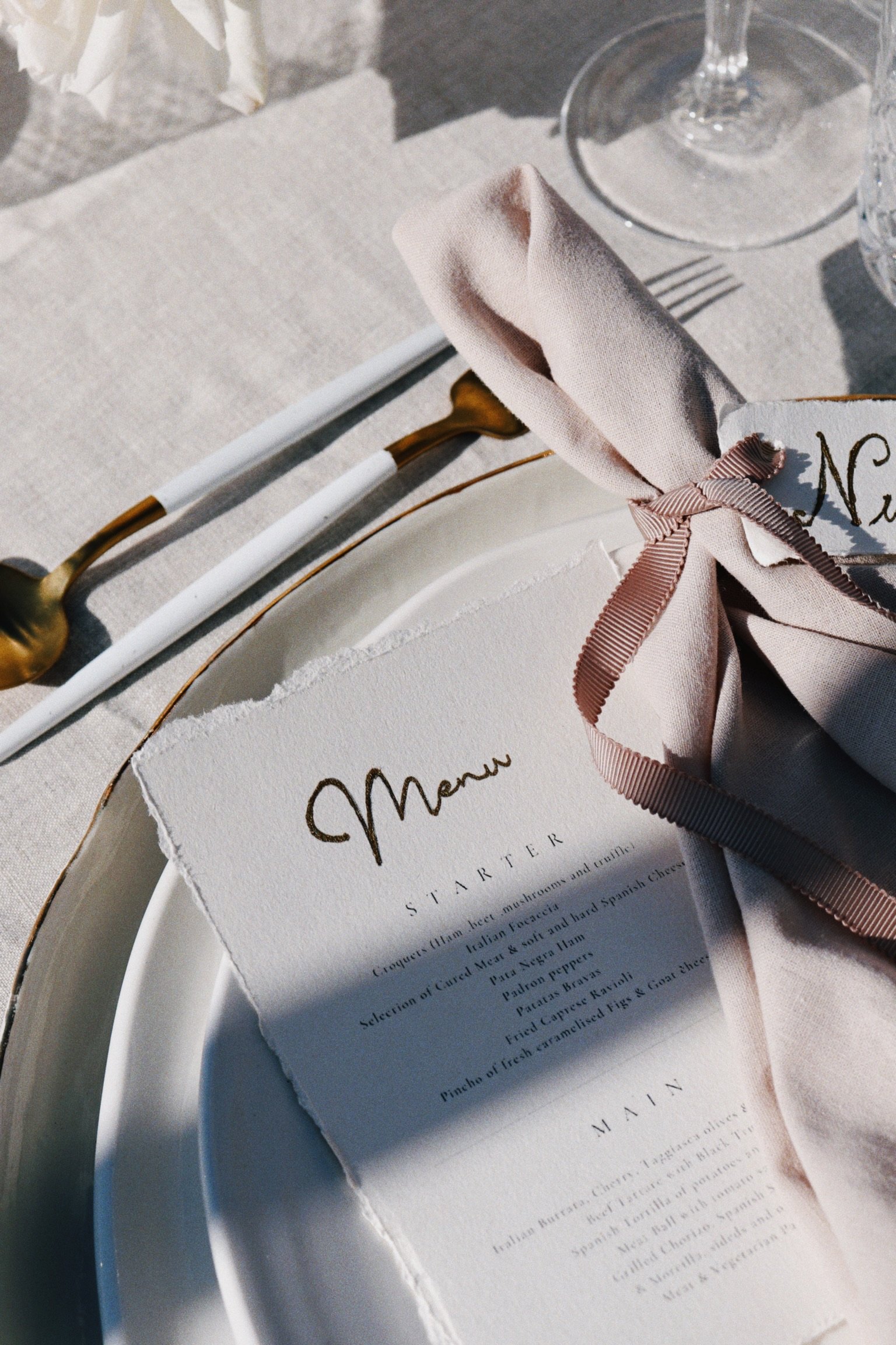 Intimate dinner setup with suspended florals and elegant place settings, vow renewal Ibiza