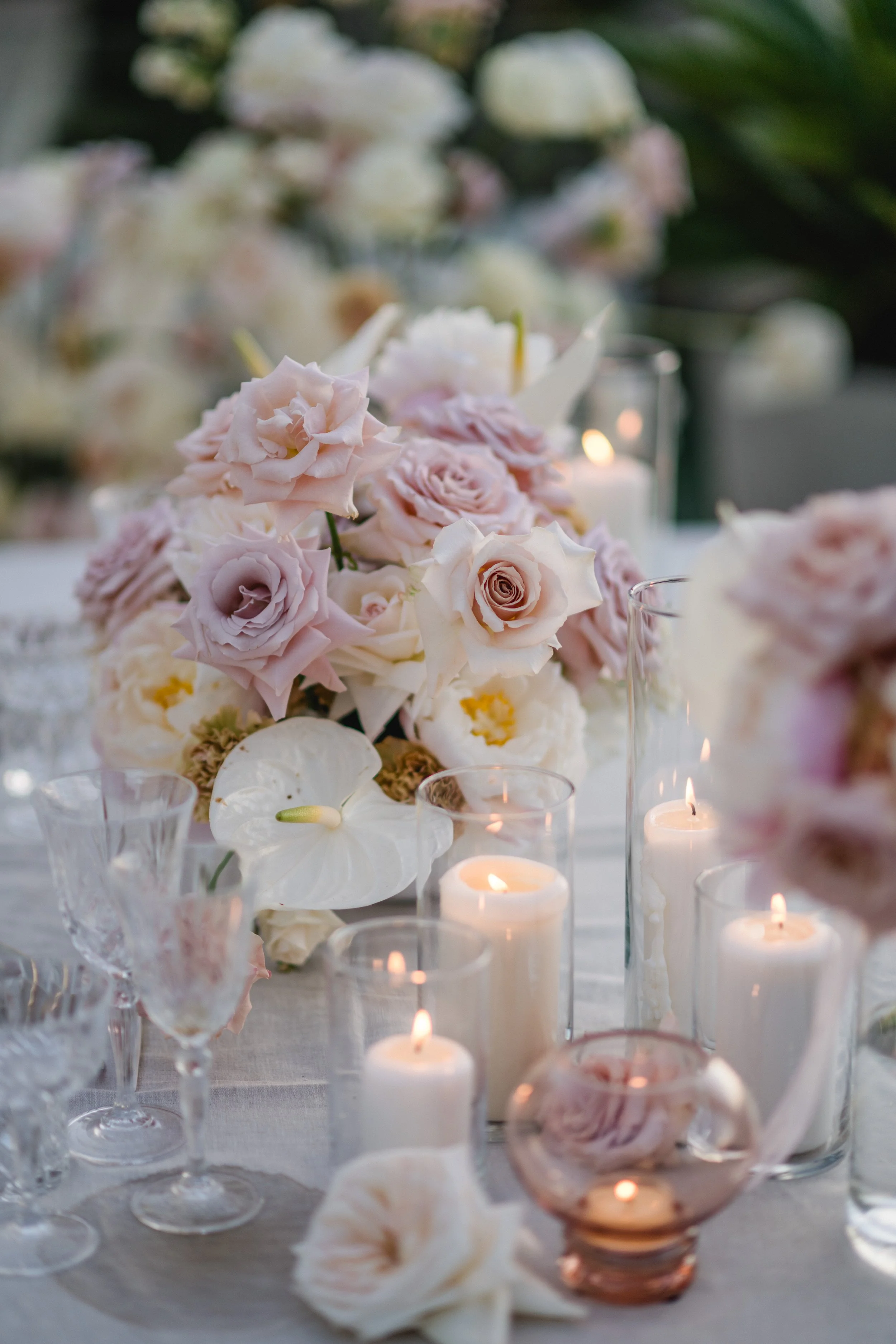 Intimate dinner setup with suspended florals and elegant place settings, vow renewal Ibiza