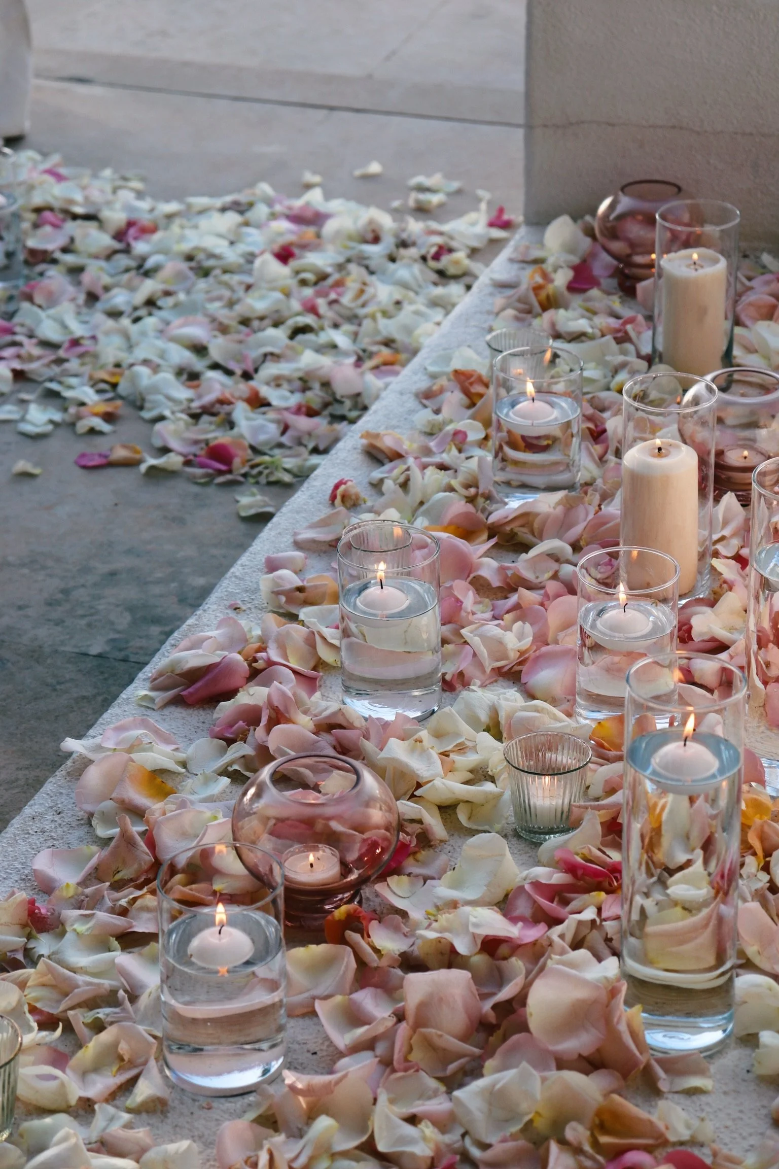 Romantic candlelit dinner table for two with cascading florals and crystal chandeliers, Ibiza