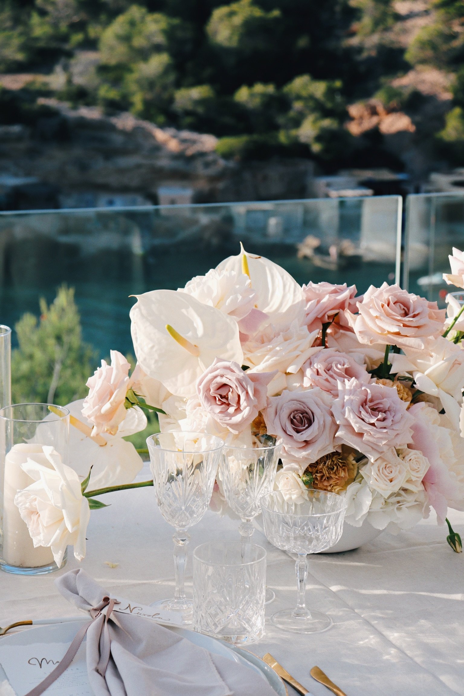 Intimate dinner setup with suspended florals and elegant place settings, vow renewal Ibiza