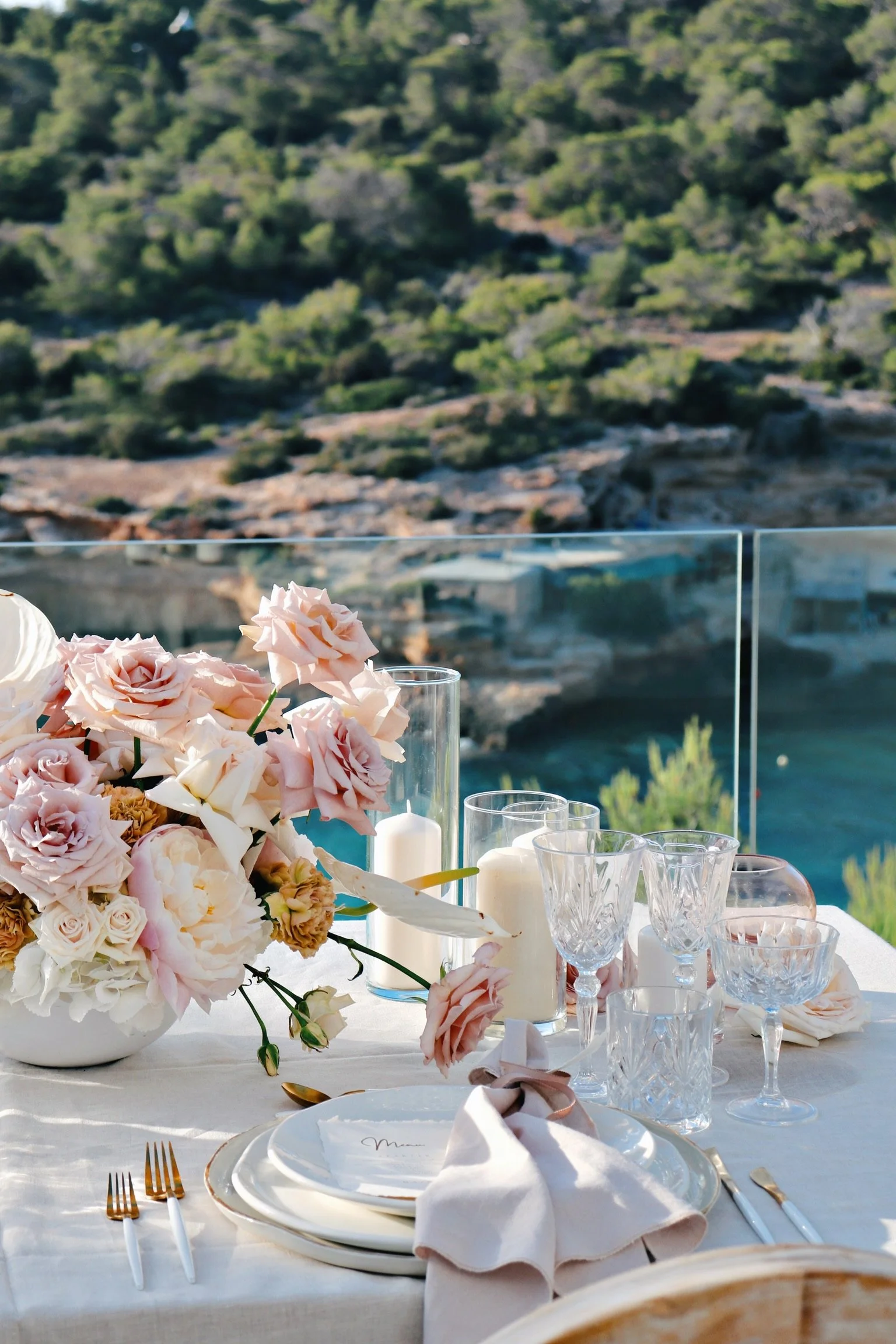 Intimate dinner setup with suspended florals and elegant place settings, vow renewal Ibiza"