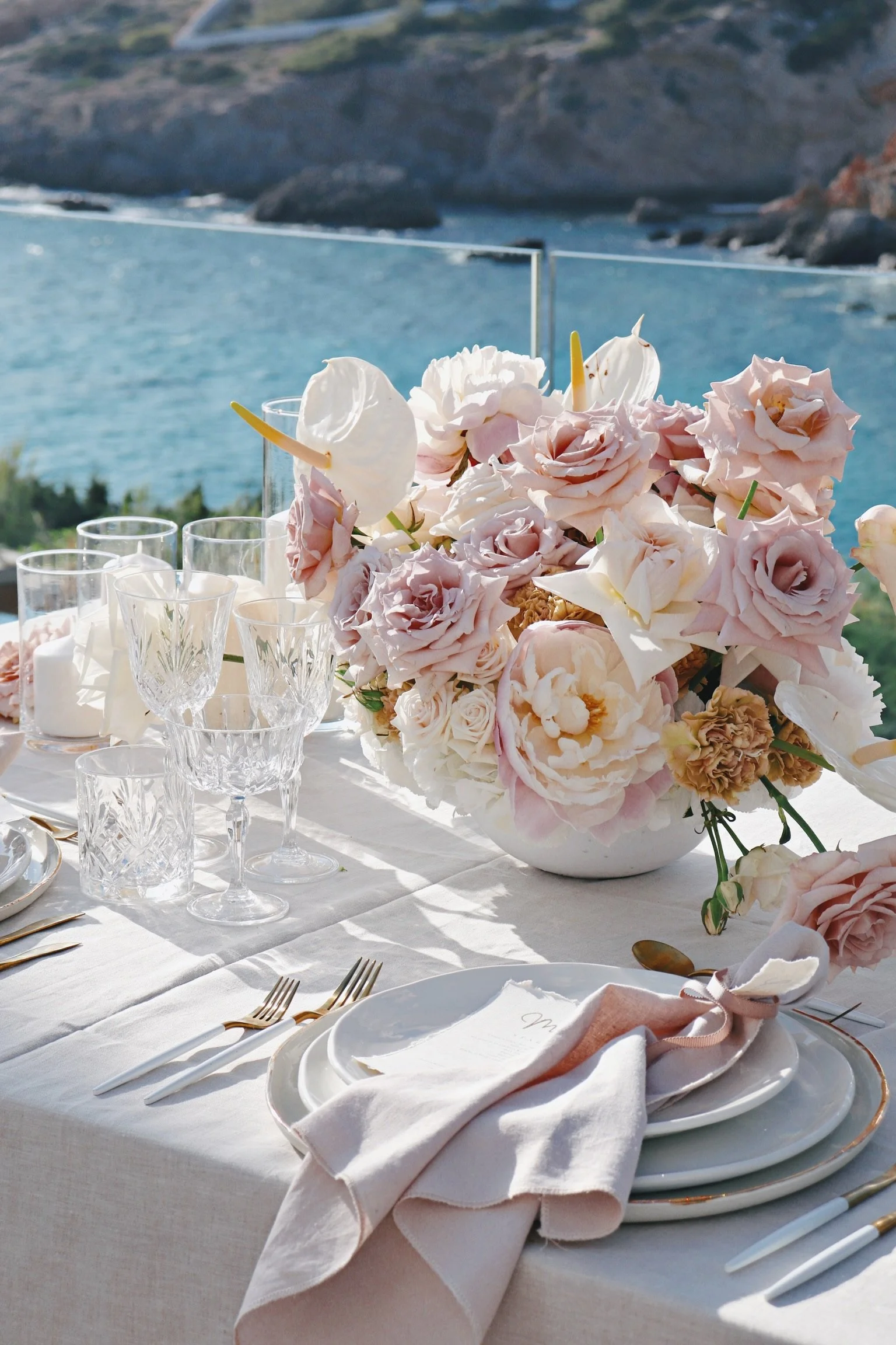 Intimate dinner setup with suspended florals and elegant place settings, vow renewal Ibiza