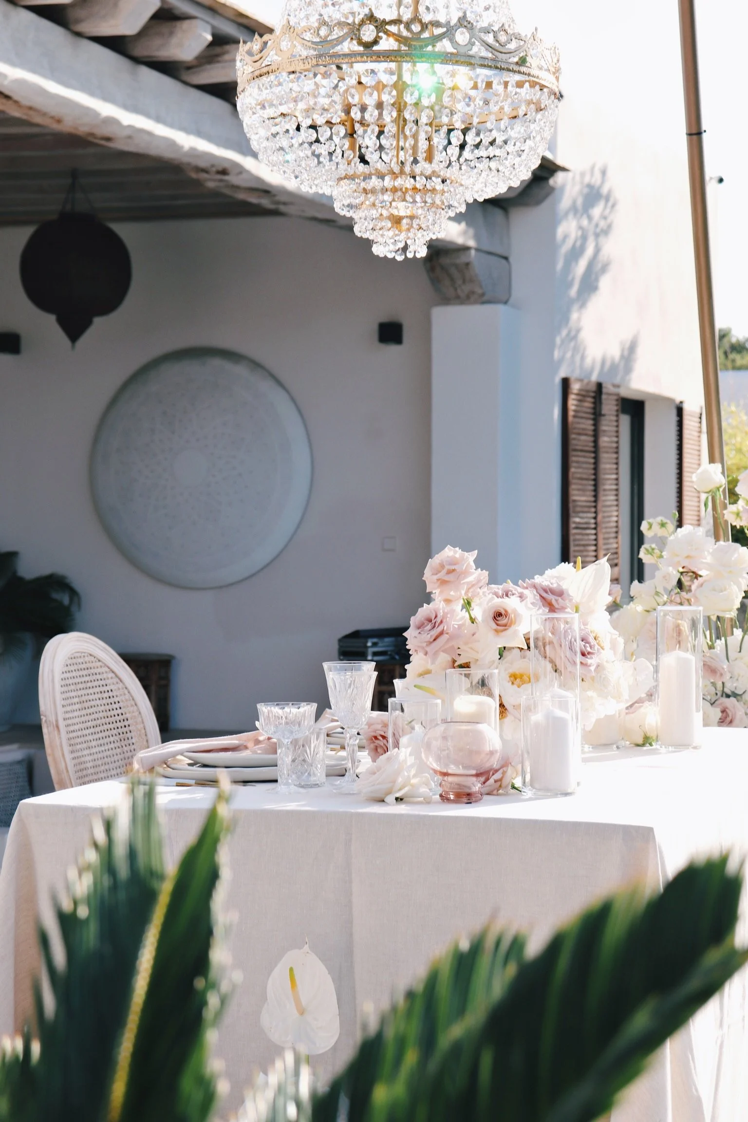Intimate dinner setup with suspended florals and elegant place settings, vow renewal Ibiza"