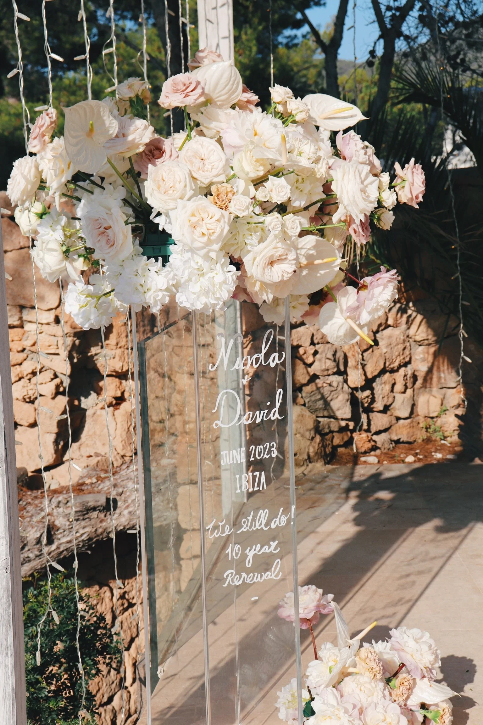 Romantic candlelit dinner table for two with cascading florals and crystal chandeliers, Ibiza