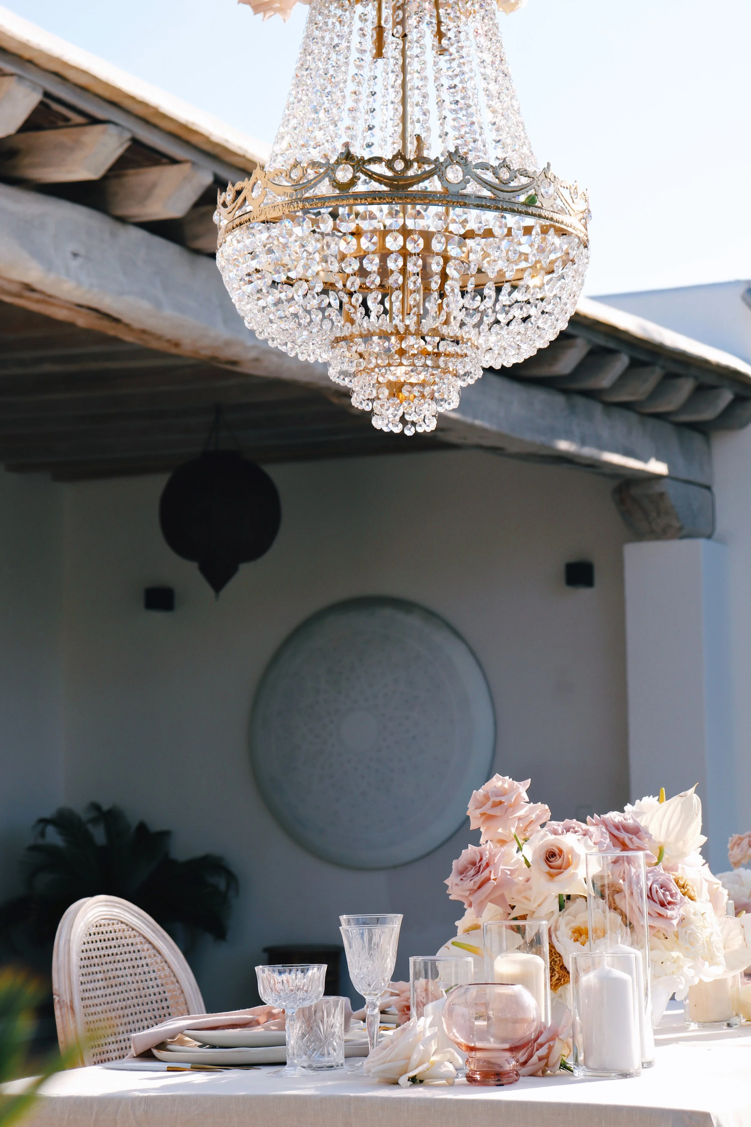Intimate dinner setup with suspended florals and elegant place settings, vow renewal Ibiza"