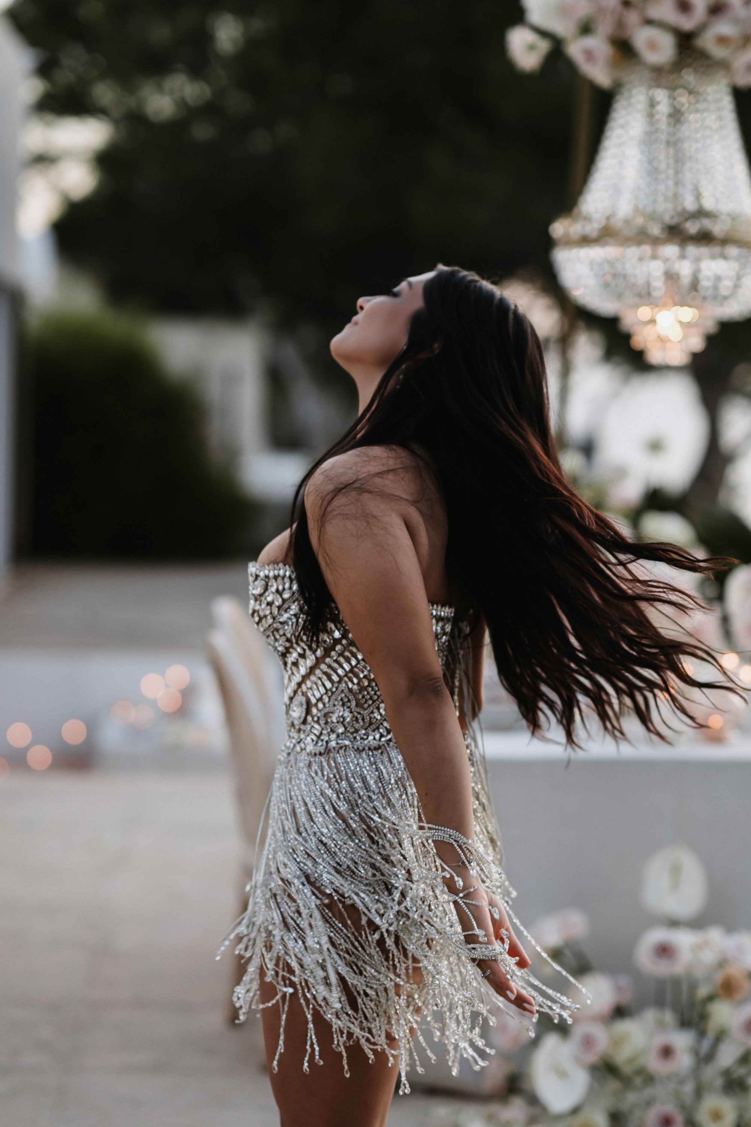 Bride twirling in sparkly cocktail dress at intimate villa celebration, Ibiza wedding