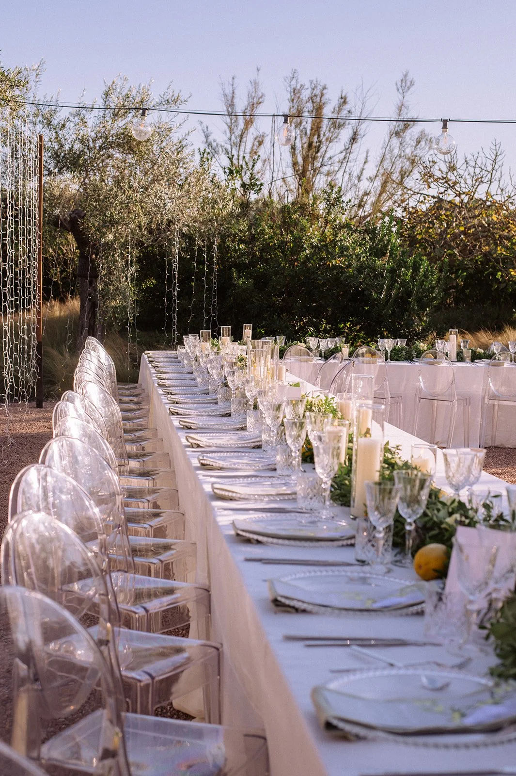 Ibiza wedding reception , stylish tables with festoon lighting and olive trees