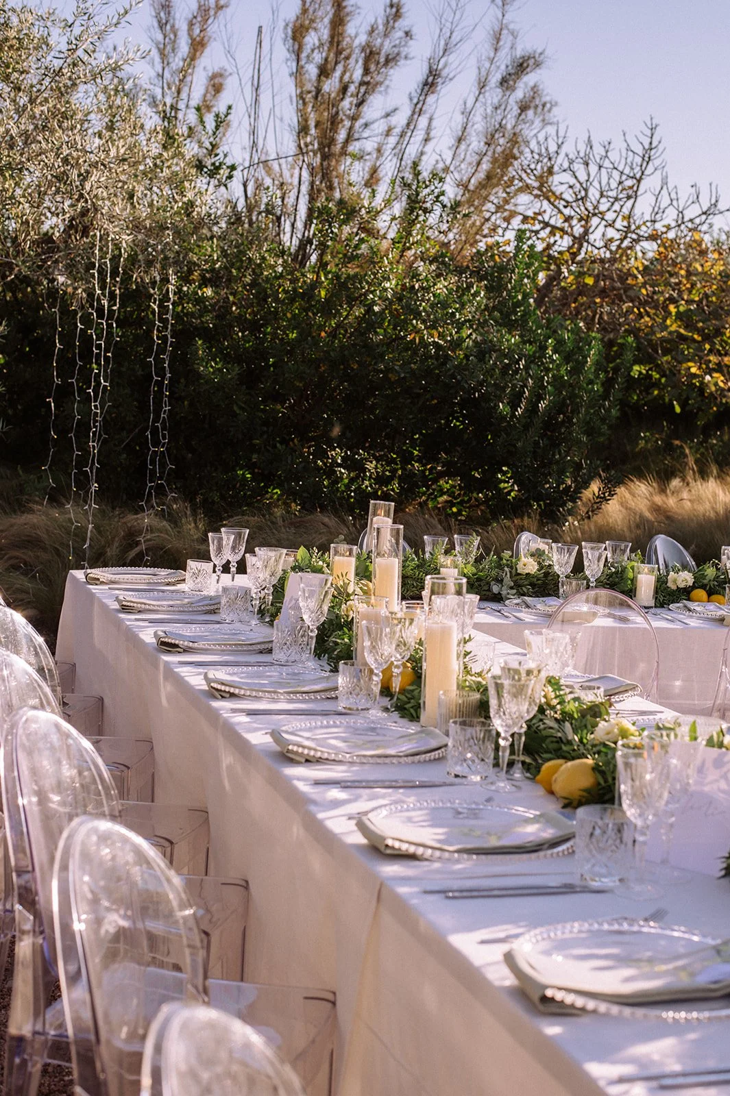 Ibiza wedding reception , stylish tables with festoon lighting and olive trees