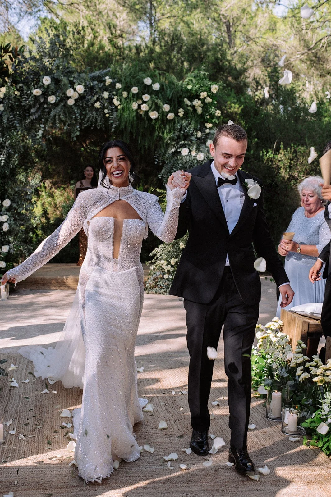 Bride and groom walking down aisle with bubble send-off, Ca Na Xica Ibiza