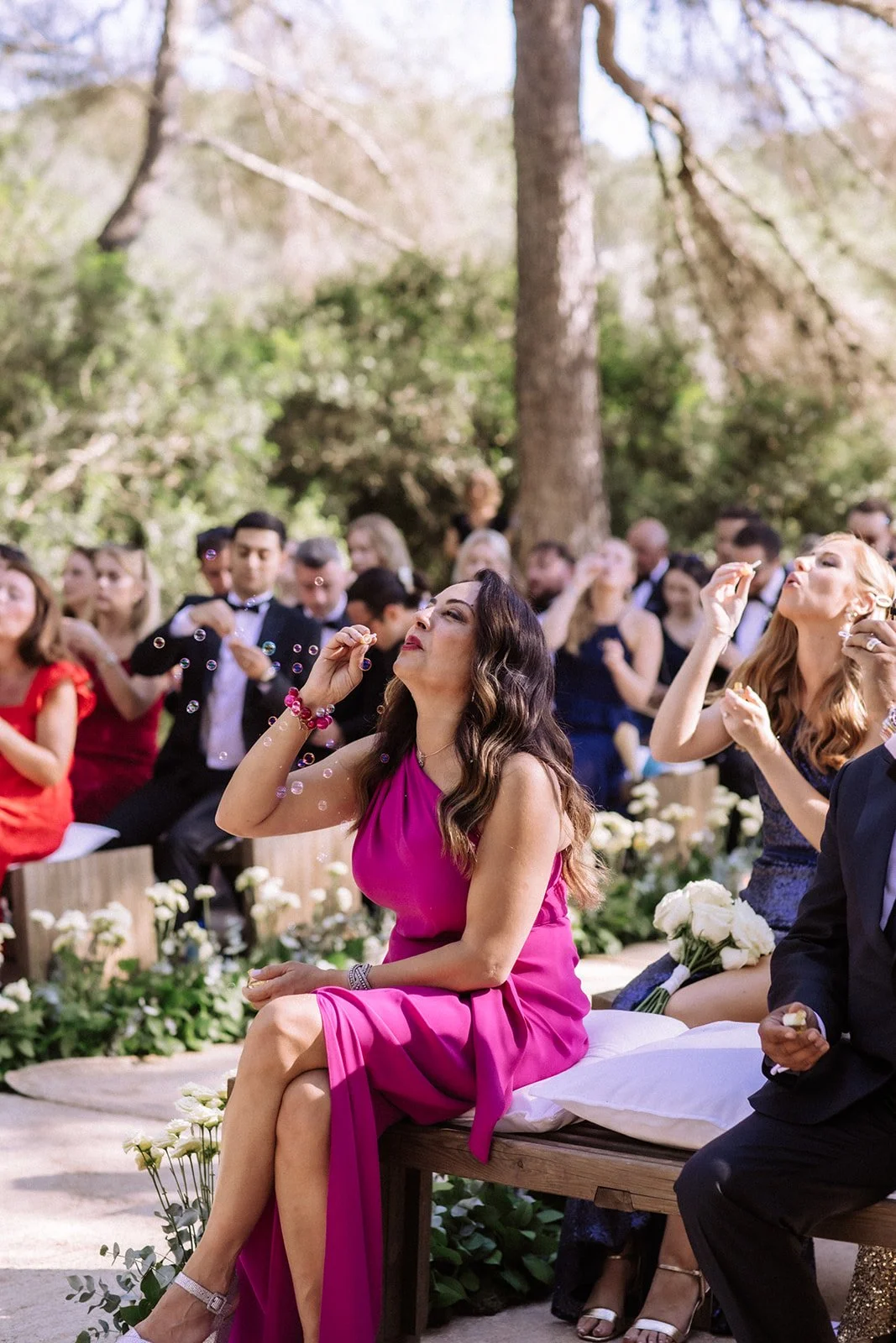 Modern wedding ceremony with guests in vibrant colors, Ibiza celebration