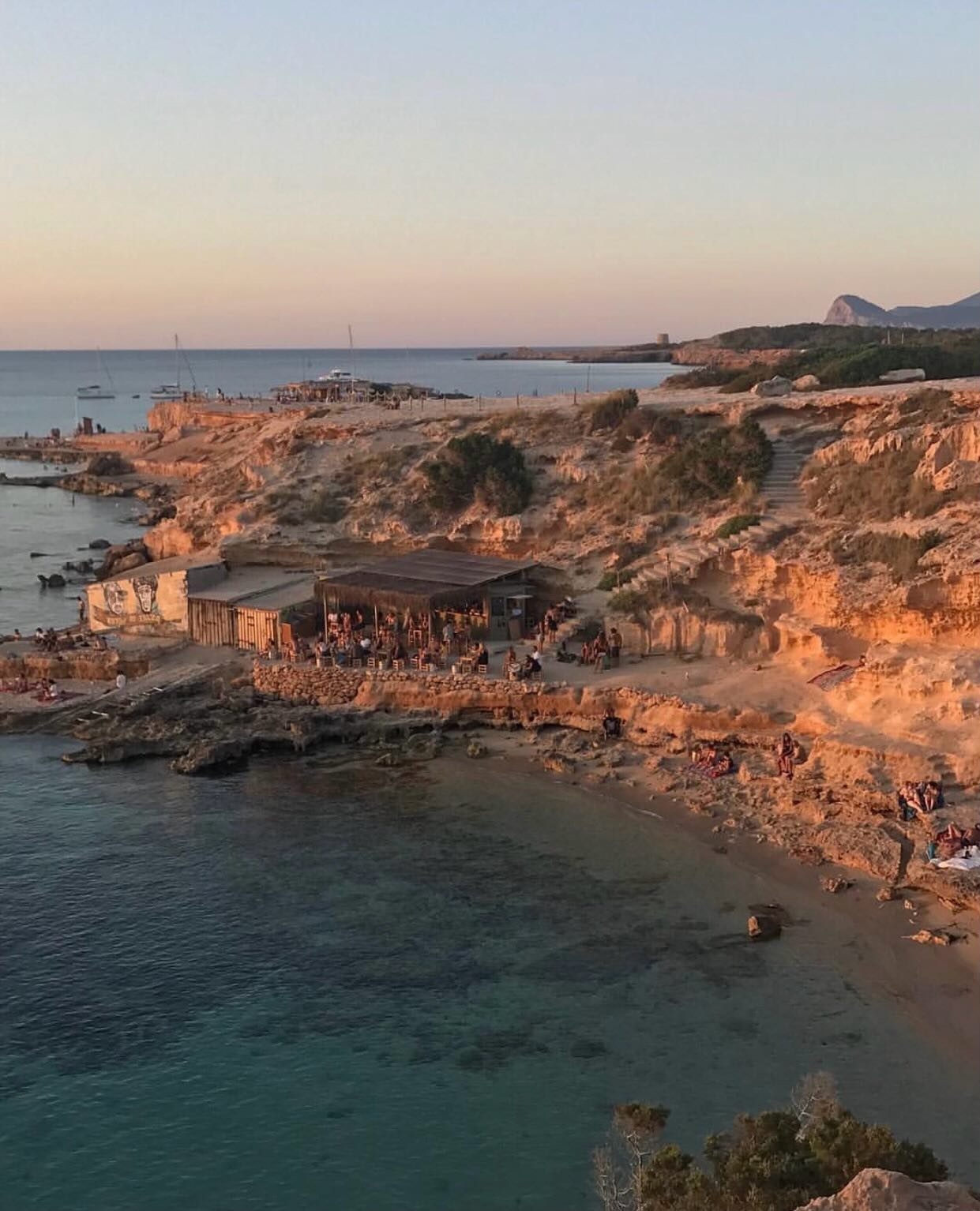 After all these years Ibiza still stops us in our tracks. 

The light that turns everything golden, the handful of coves that still feel like secrets, the old town stories whispered through weathered wooden doors, the magical and iconic sunsets, the 