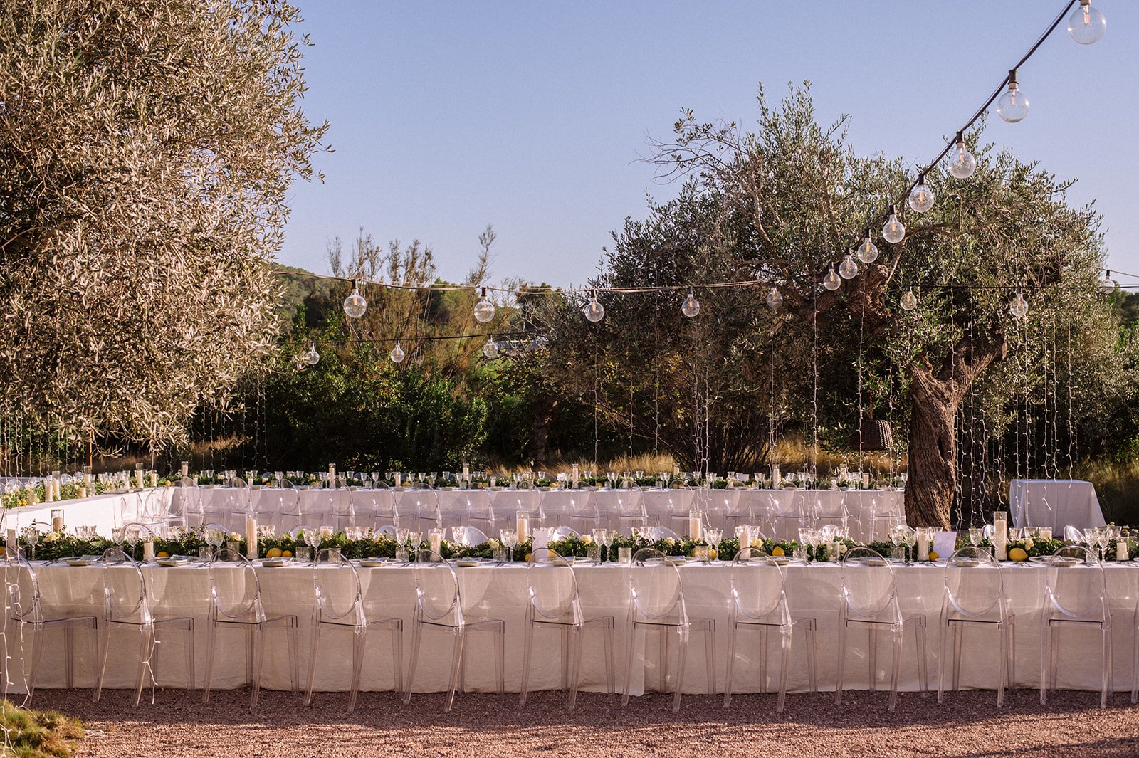 Ibiza wedding reception , stylish tables with festoon lighting and olive trees