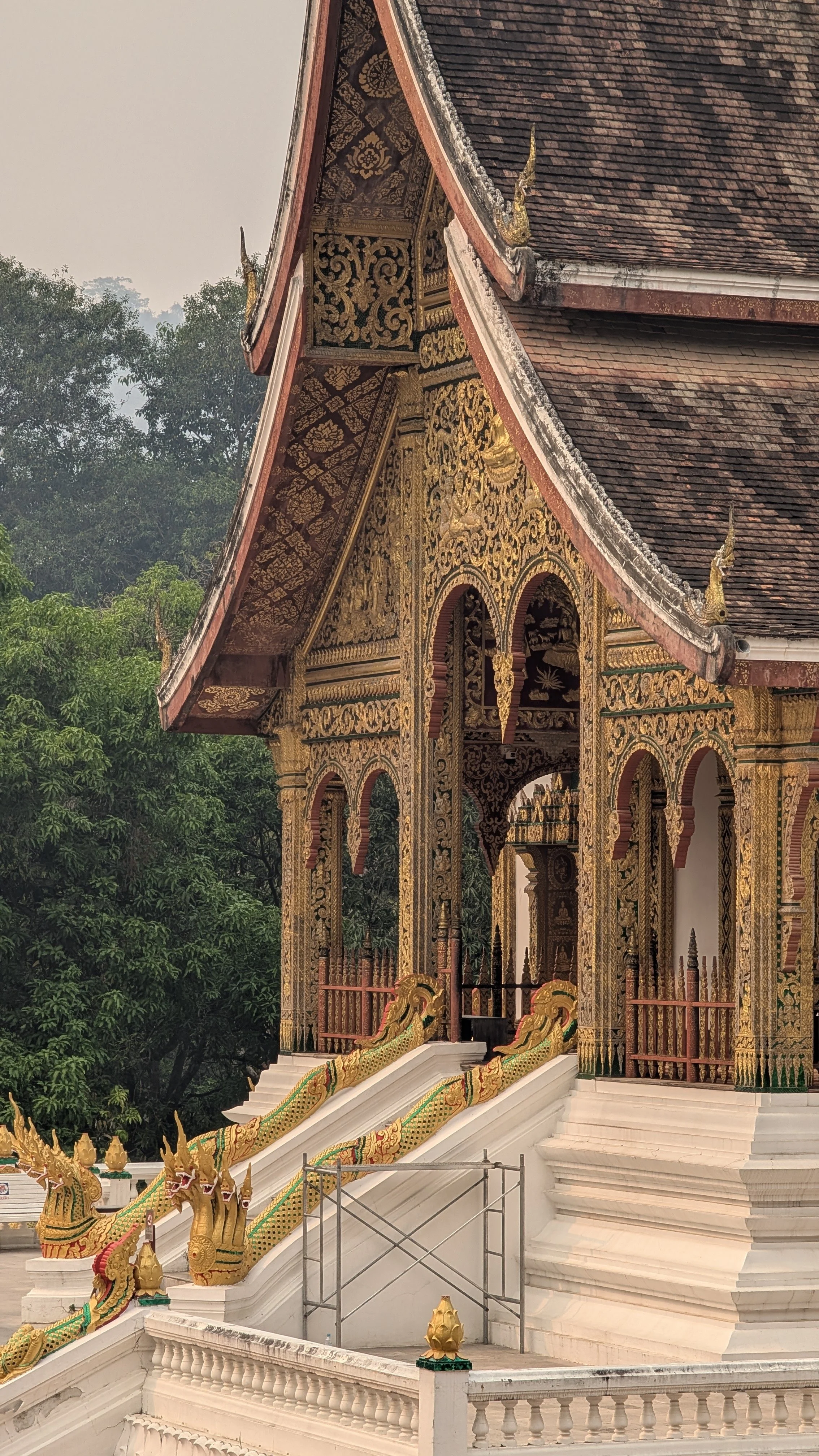 Façade dorée et toitures sculptées du Sim d'un temple bouddhiste traditionnel à Luang Prabang.
