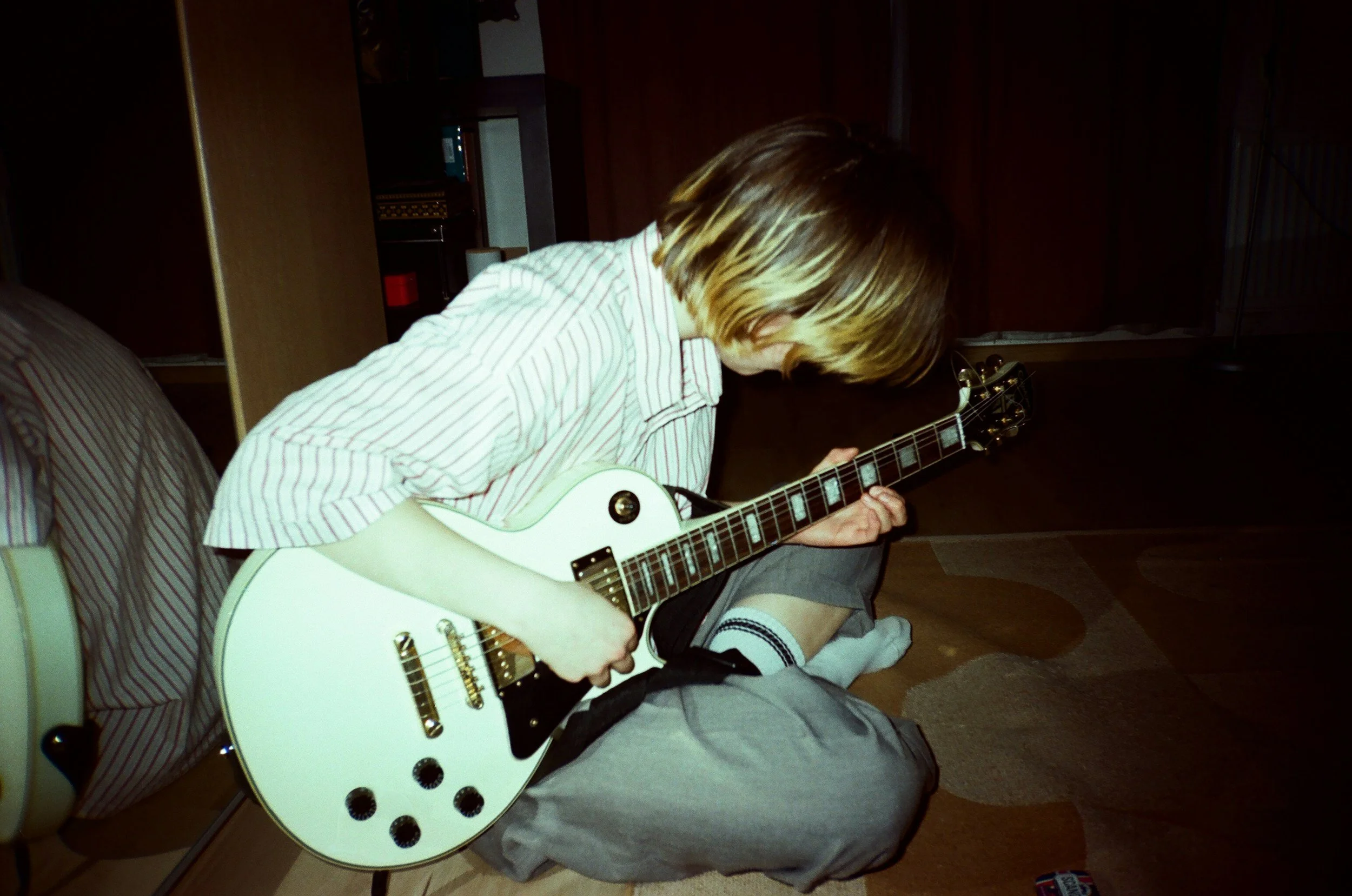 Youth player with a guitar, representing a young player Simon from Wrexham Guitars has taught.