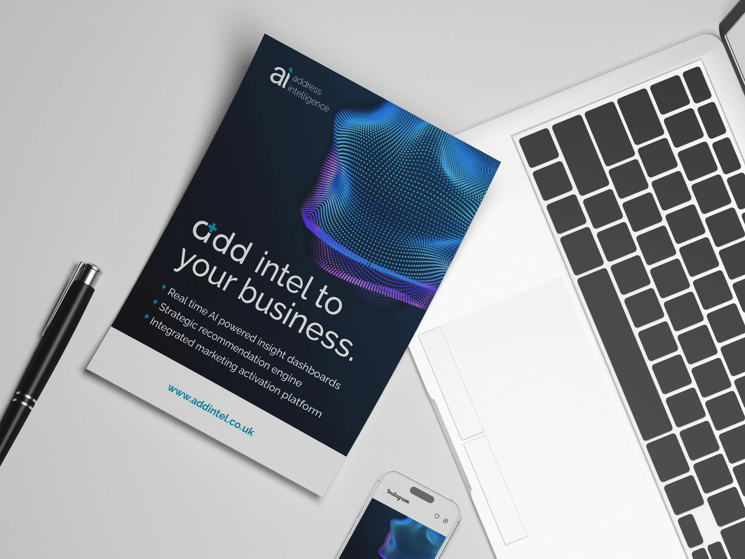 Business flyer on a white desk promoting adding AI to businesses with features like real-time dashboards, AI engine, and marketing platform, next to a laptop, smartphone, and pen.