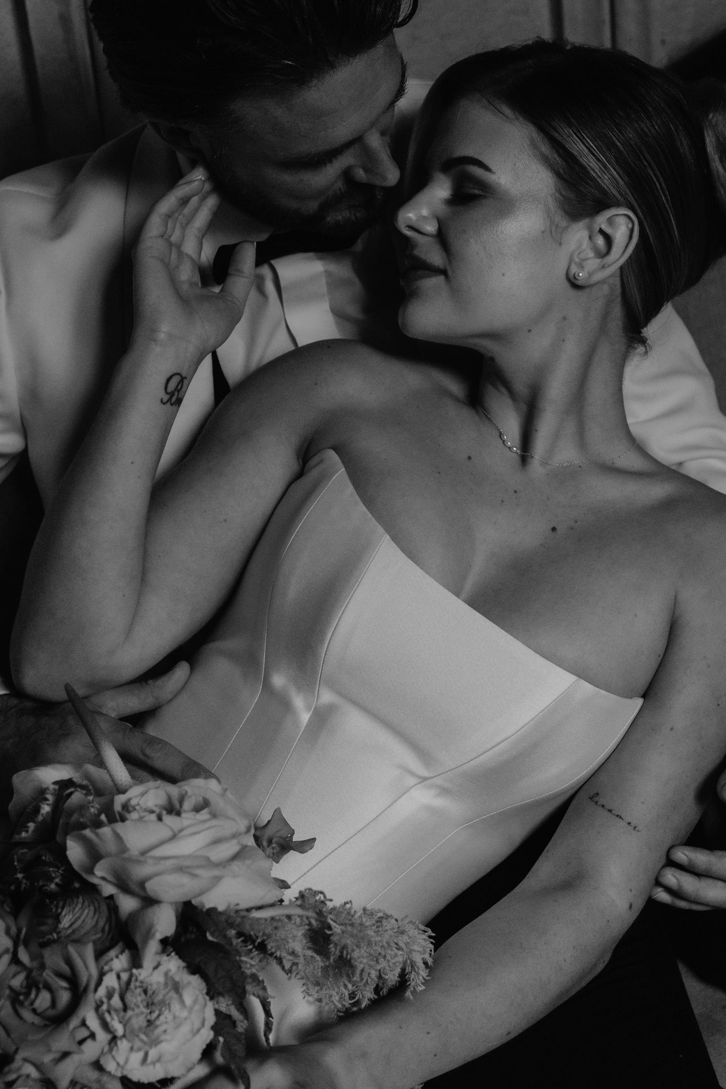 A black and white photo of a couple on their wedding day, close together with their foreheads touching. . wedding at euridge manor, documentary wedding photographer 