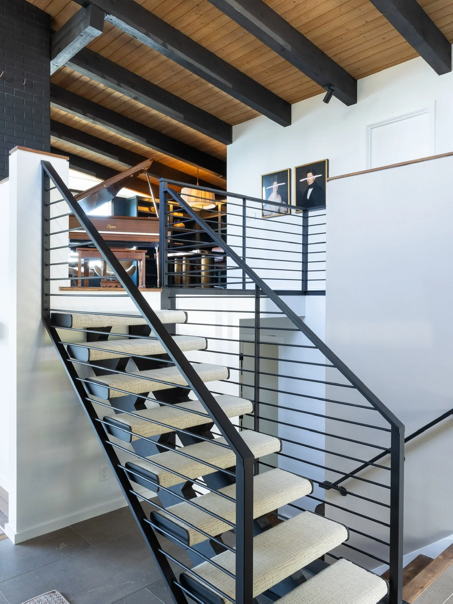 The library loft above the living room became a music room and office - the family now enjoys the piano throughout the house with a breathtaking view from the workspace. 

#interiordesign #interiordesigner #homedecor #homedesign #vashonisland