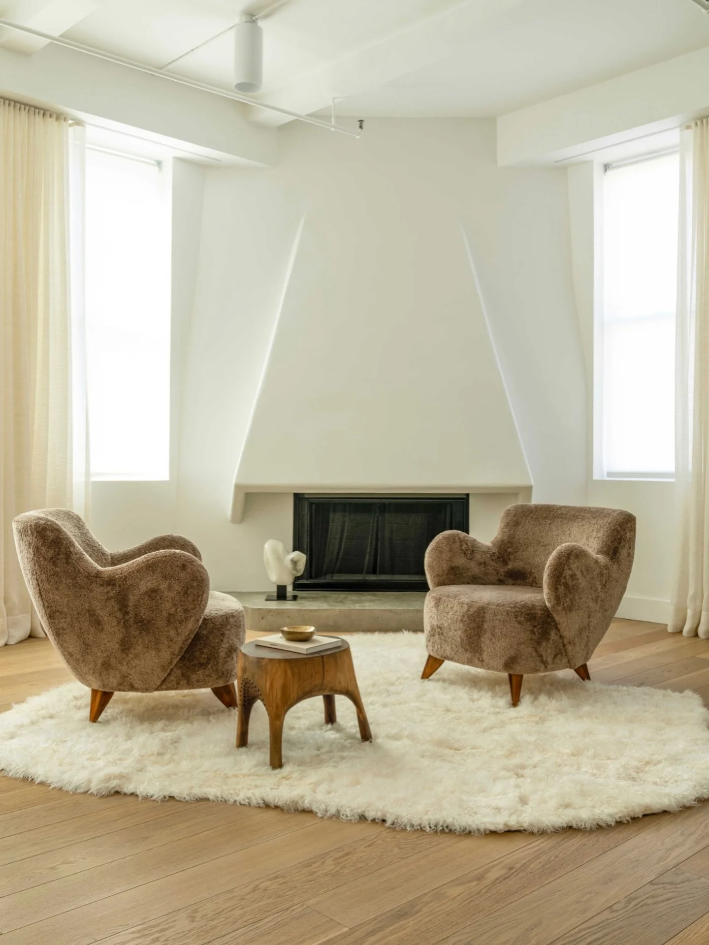 Classic forms, global touch. Barrel chairs and an African side table create a cozy pause in our contemporary Flatiron loft. Featured in @interiorsmagazine.

#interiordesign #nycinteriordesign #nycinteriordesigner #homedesign #designinspo