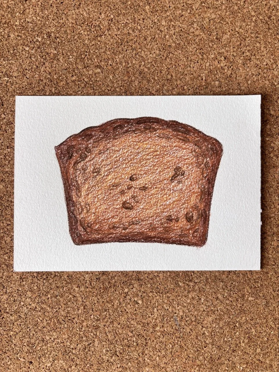 Colorful drawing of a slice of bread with a brown crust on a white background, placed on a cork surface.