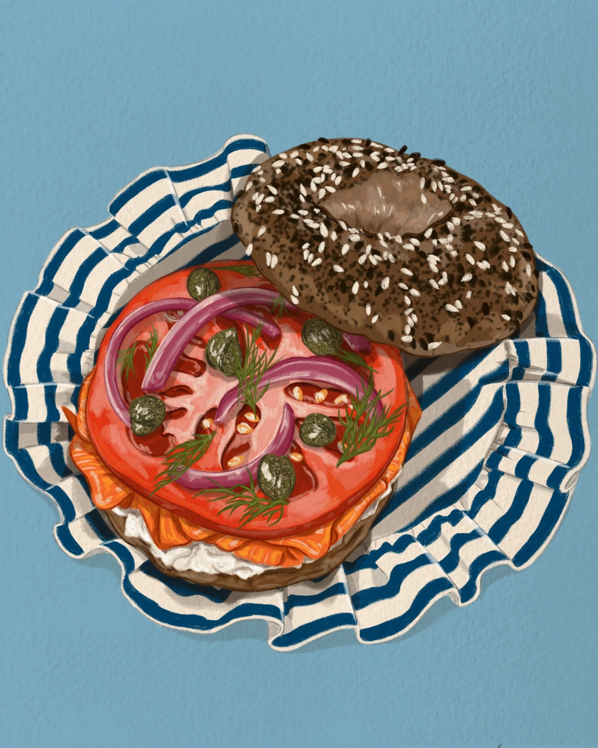 A bagel with poppy seeds topped with sesame seeds, placed on a plate with sliced tomato, red onion, pickles, and fresh dill, on a blue and white striped cloth.