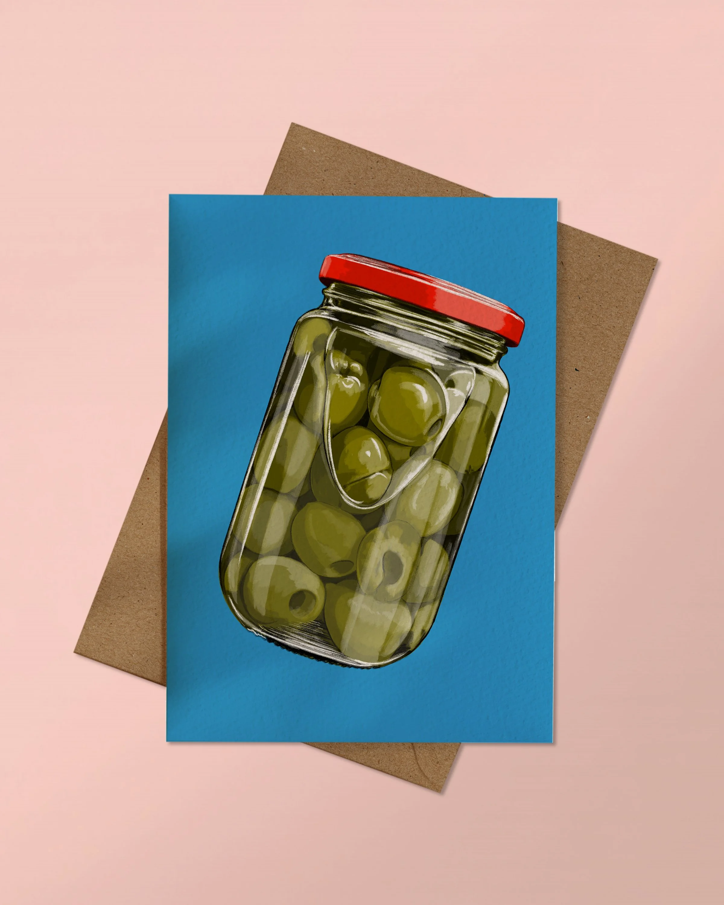 A6 Greeting Card of a jar of olives on a blue background stacked on a kraft brown envelope on a pink background.