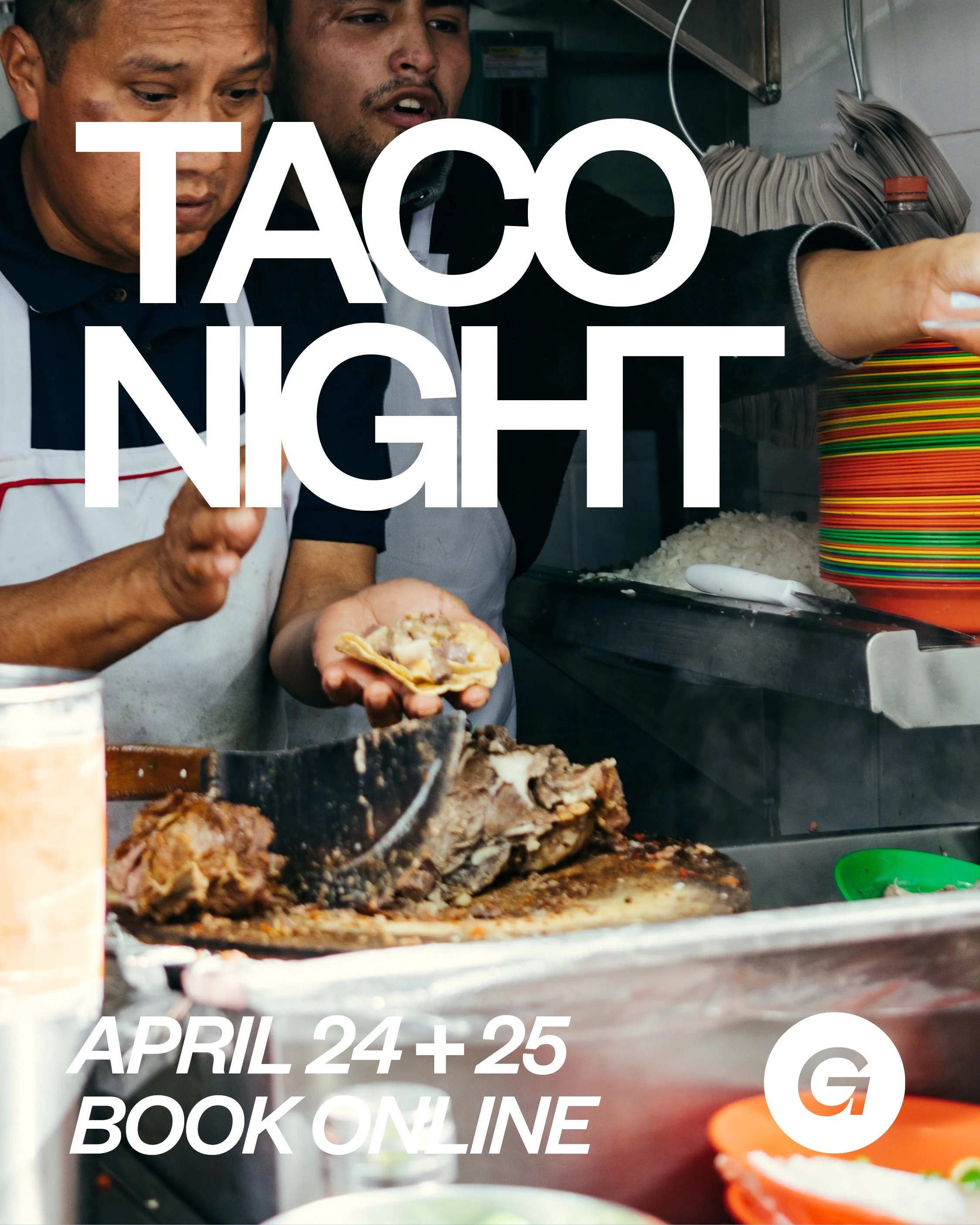 Two men cooking and preparing tacos in a kitchen, with large white text overlay that reads 'TACO NIGHT,' and additional text below stating 'April 24 + 25 Book Online.'