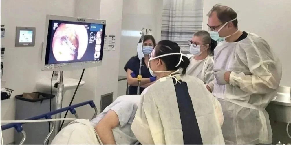 Dr. Daniel von Renteln and Medical team performing an endoscopy procedure on a patient in a hospital room.