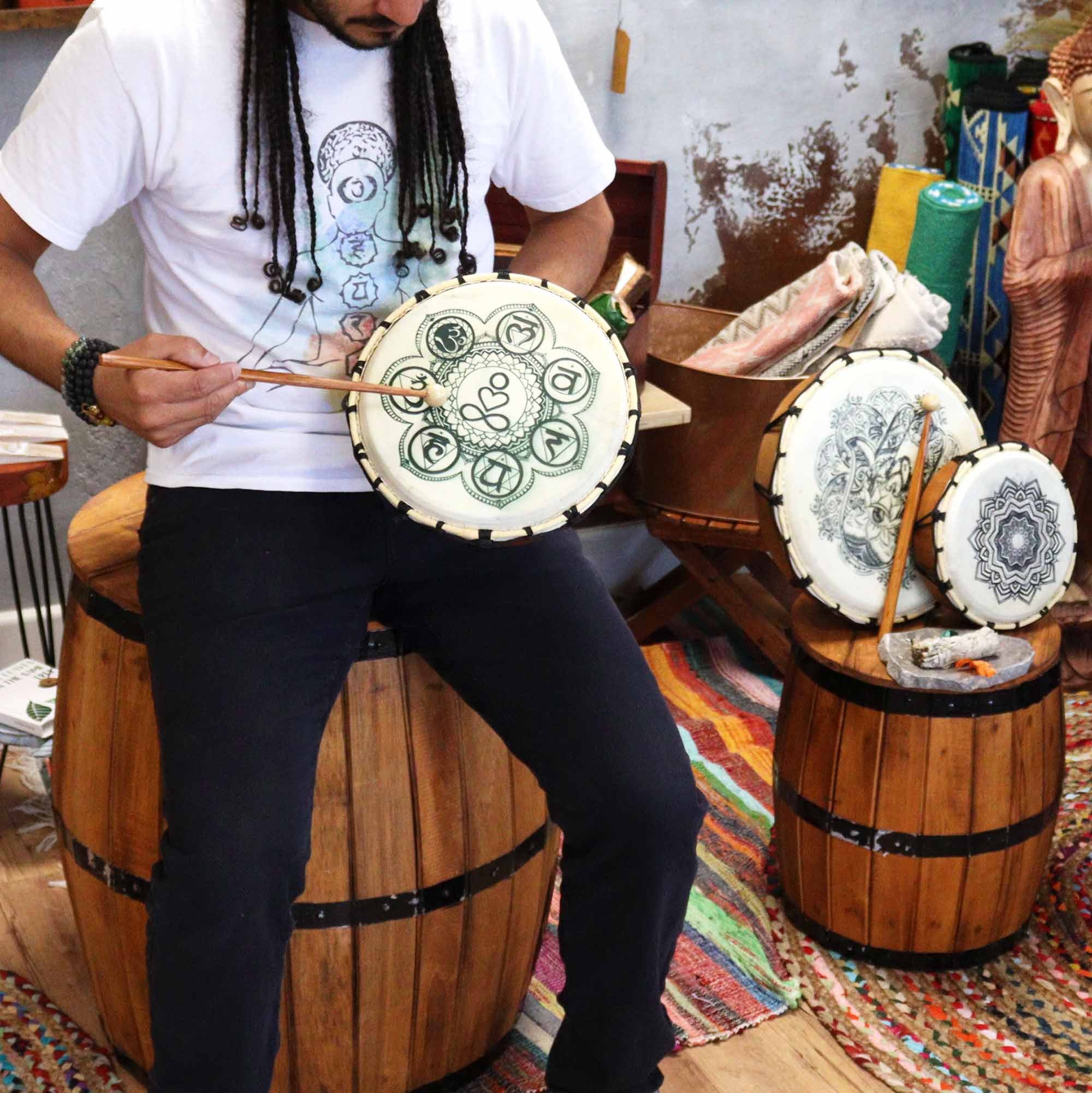 Shamanic Drum with Sticks Chakra Design 25cm being played.jpeg