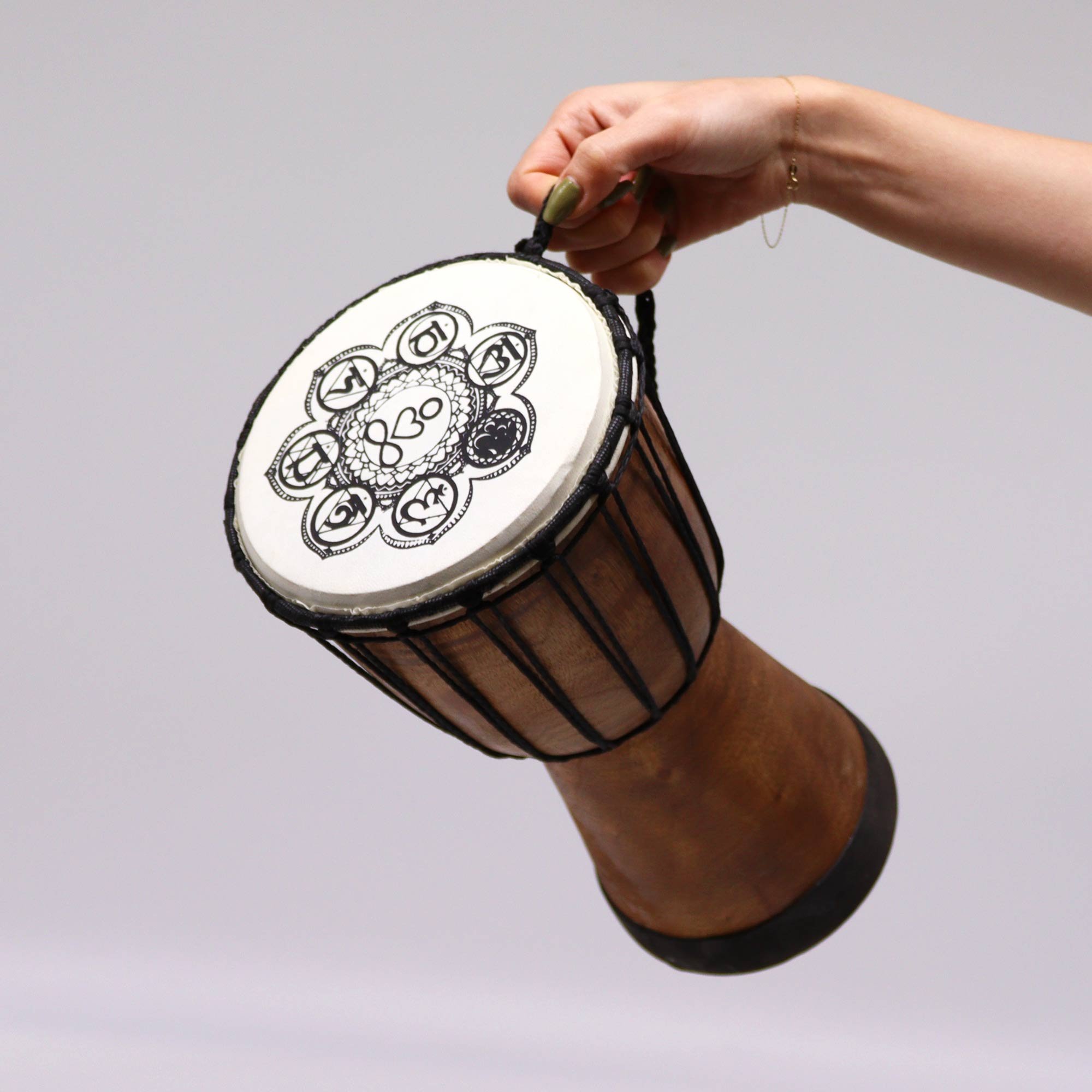 Wide Top Chakra Design Djembe 17cm Drum being carried.jpeg