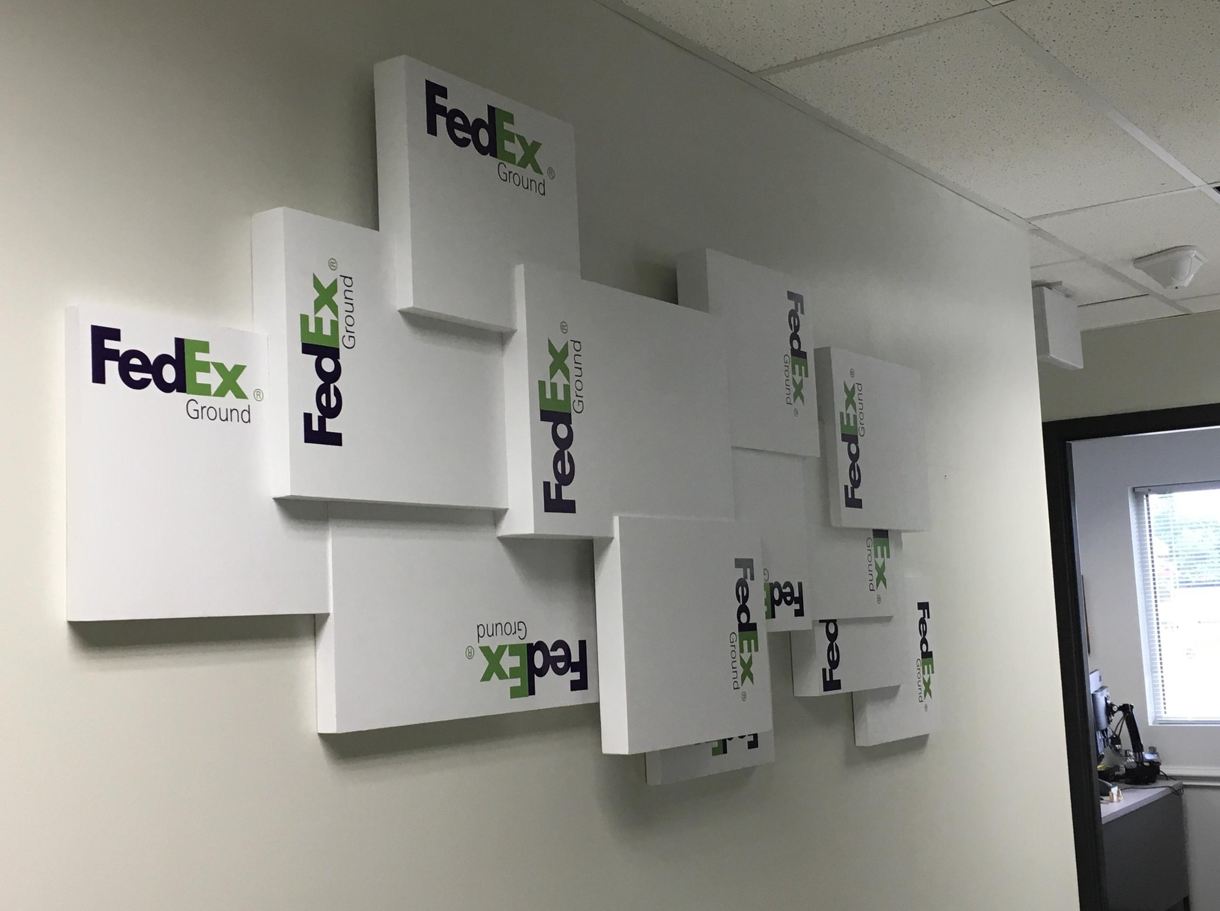Wall art featuring overlapping FedEx Ground boxes.
