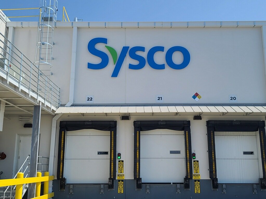 Sysco loading dock with three bay doors and signage