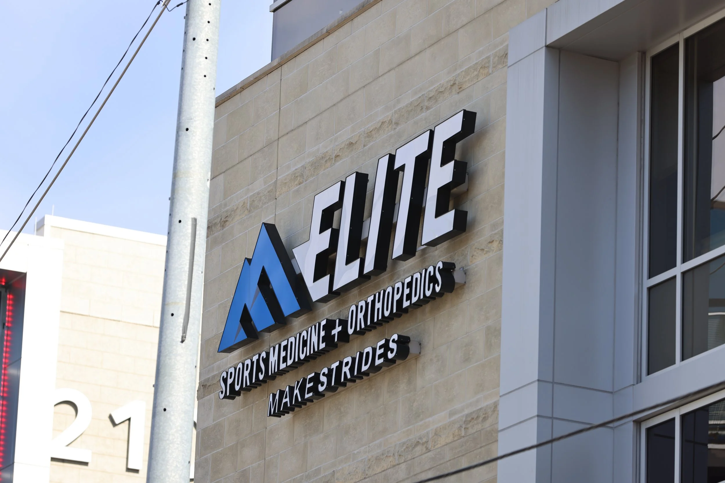 Exterior sign for Elite Sports Medicine + Orthopedics on a building.