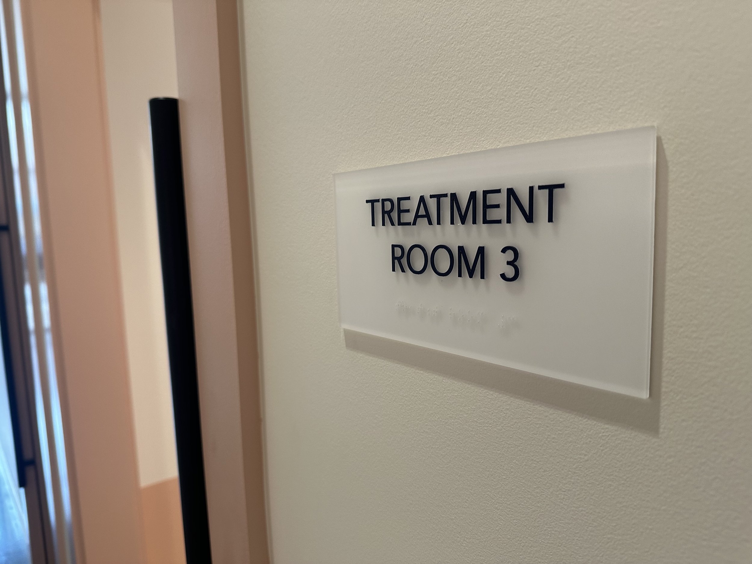 Sign on a wall reading 'Treatment Room 3'.