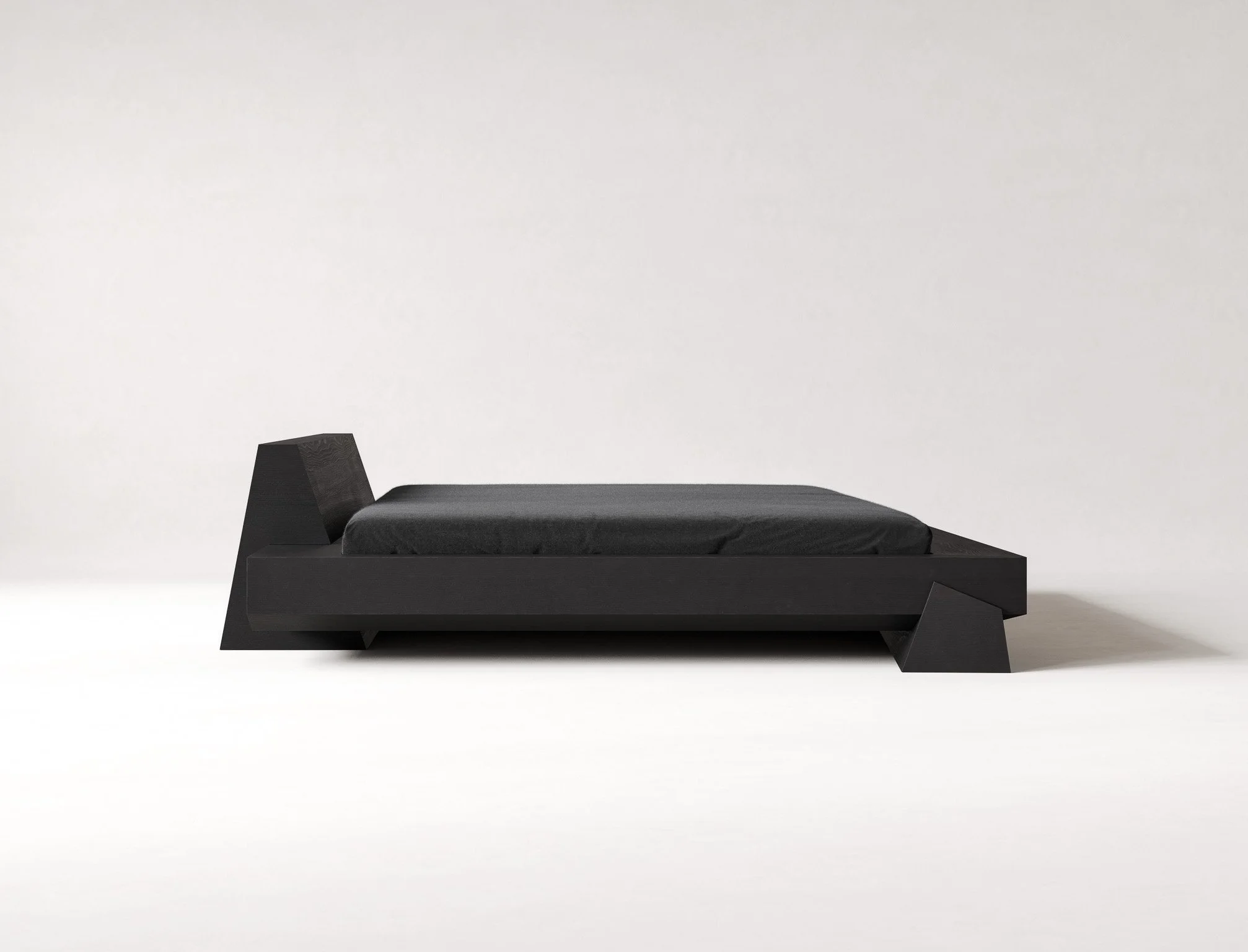 Minimalist black bed frame with black mattress on a plain white background.
