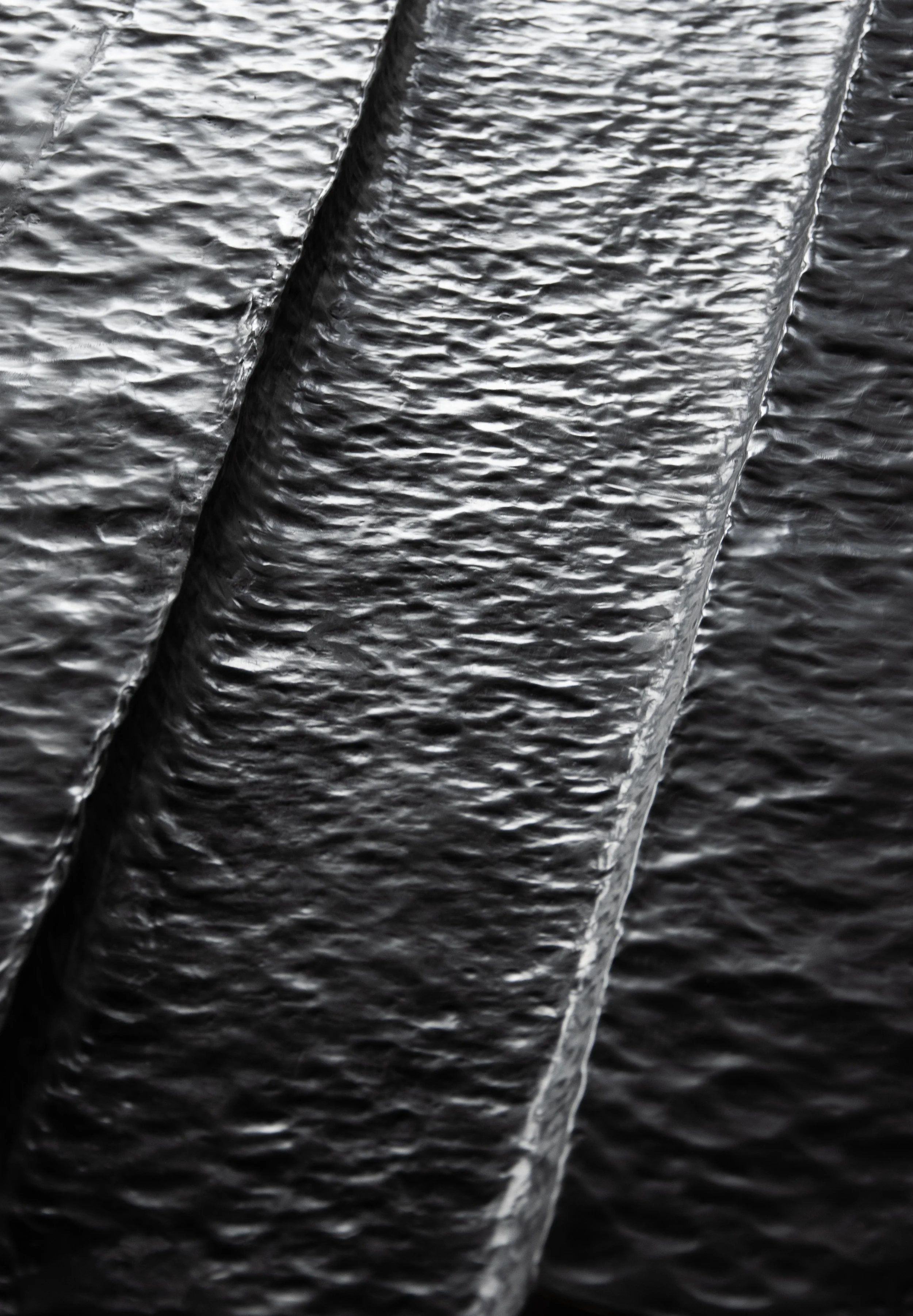 Close-up of black textured leather material showing detailed grain pattern.