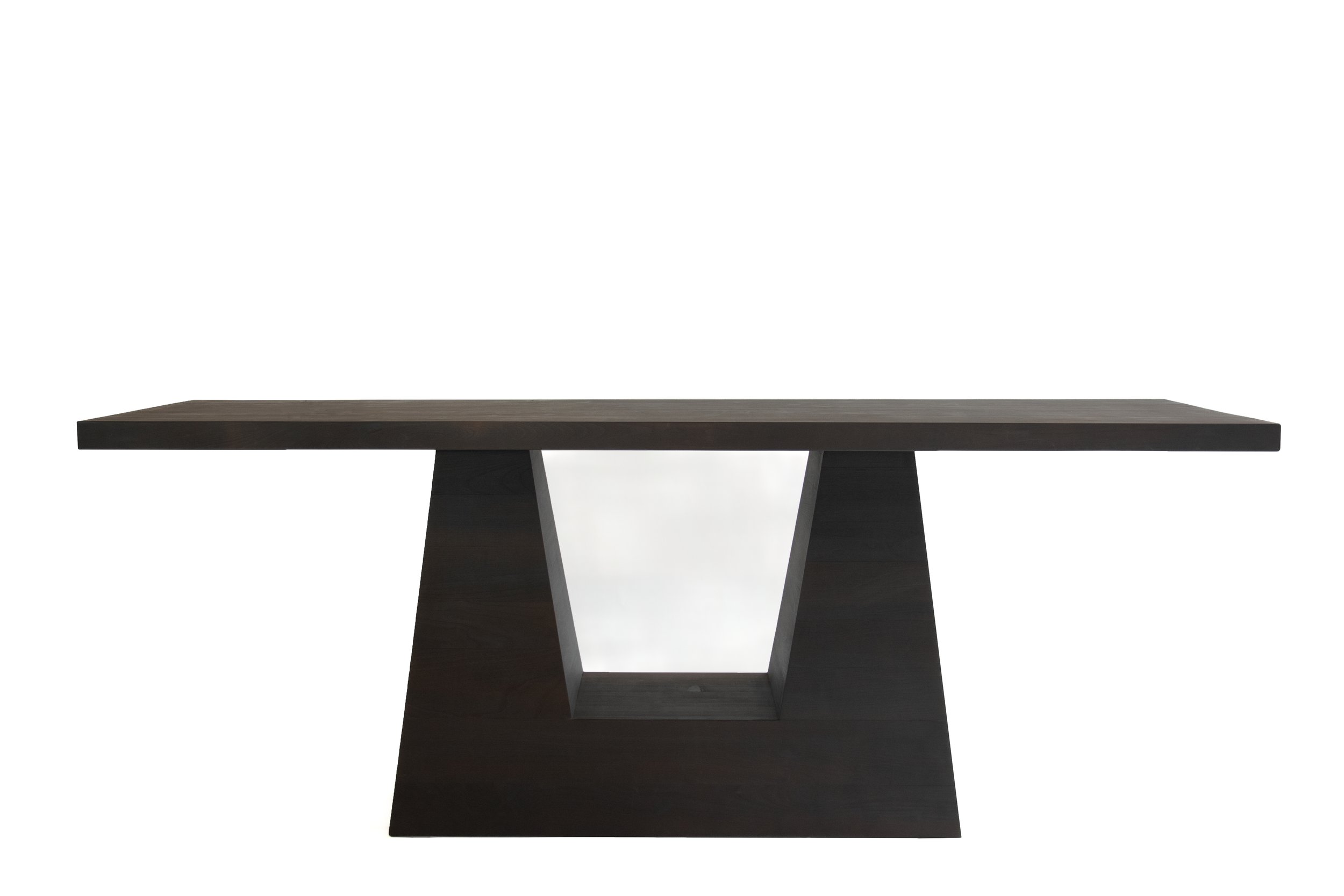 Dark wooden modern dining table with geometric base on a white background.