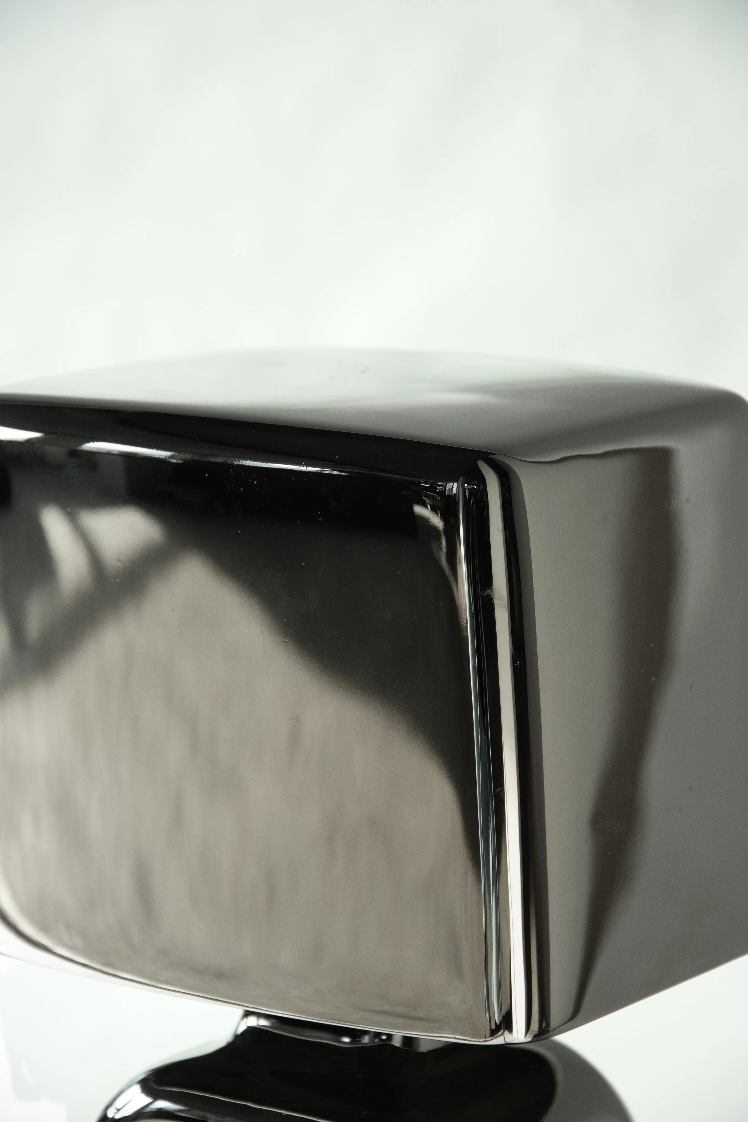 Close-up of a vintage stovetop toaster with a chrome finish.