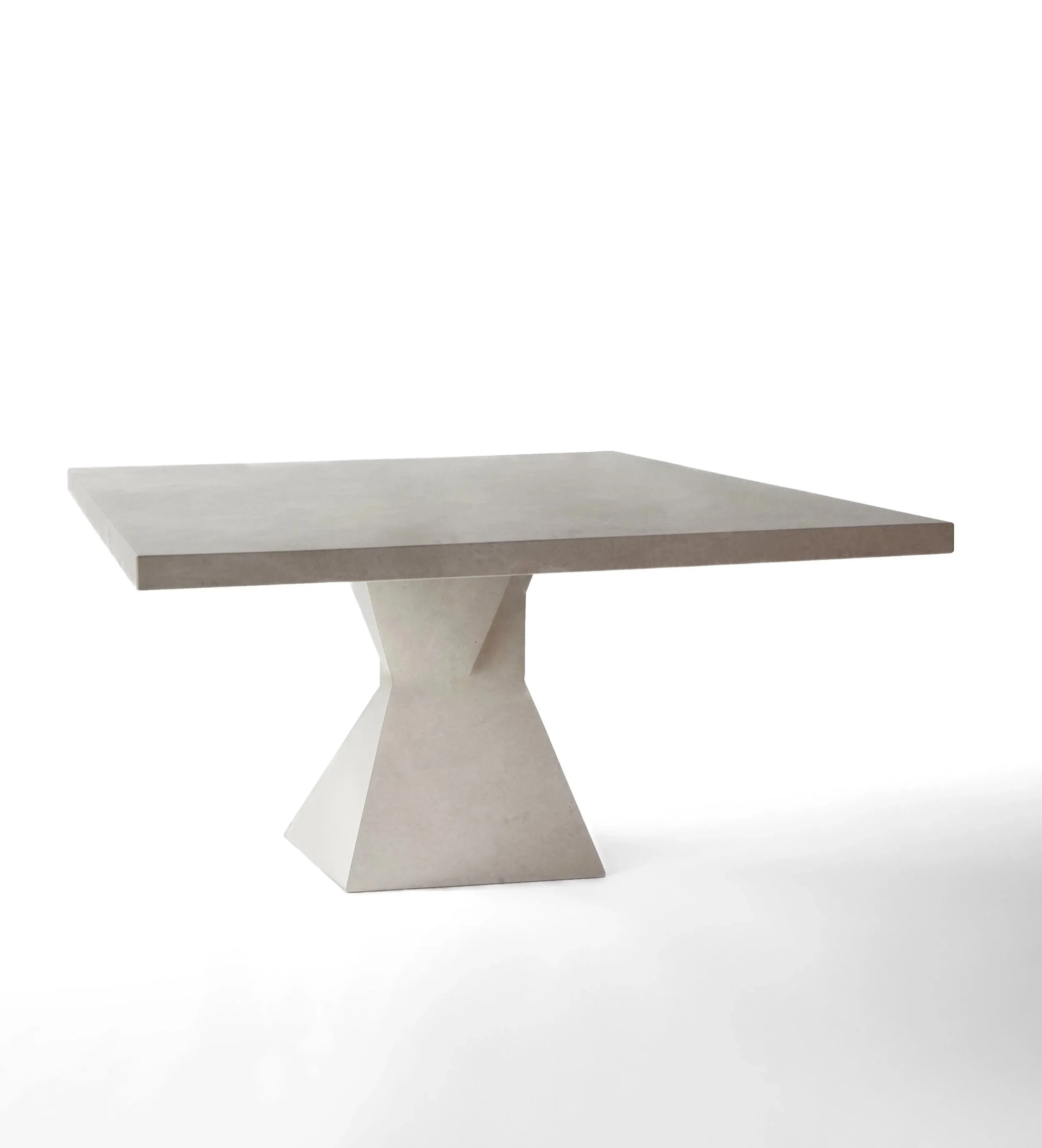 A modern, square-shaped concrete table with a unique, angular pedestal base, set against a plain white background.