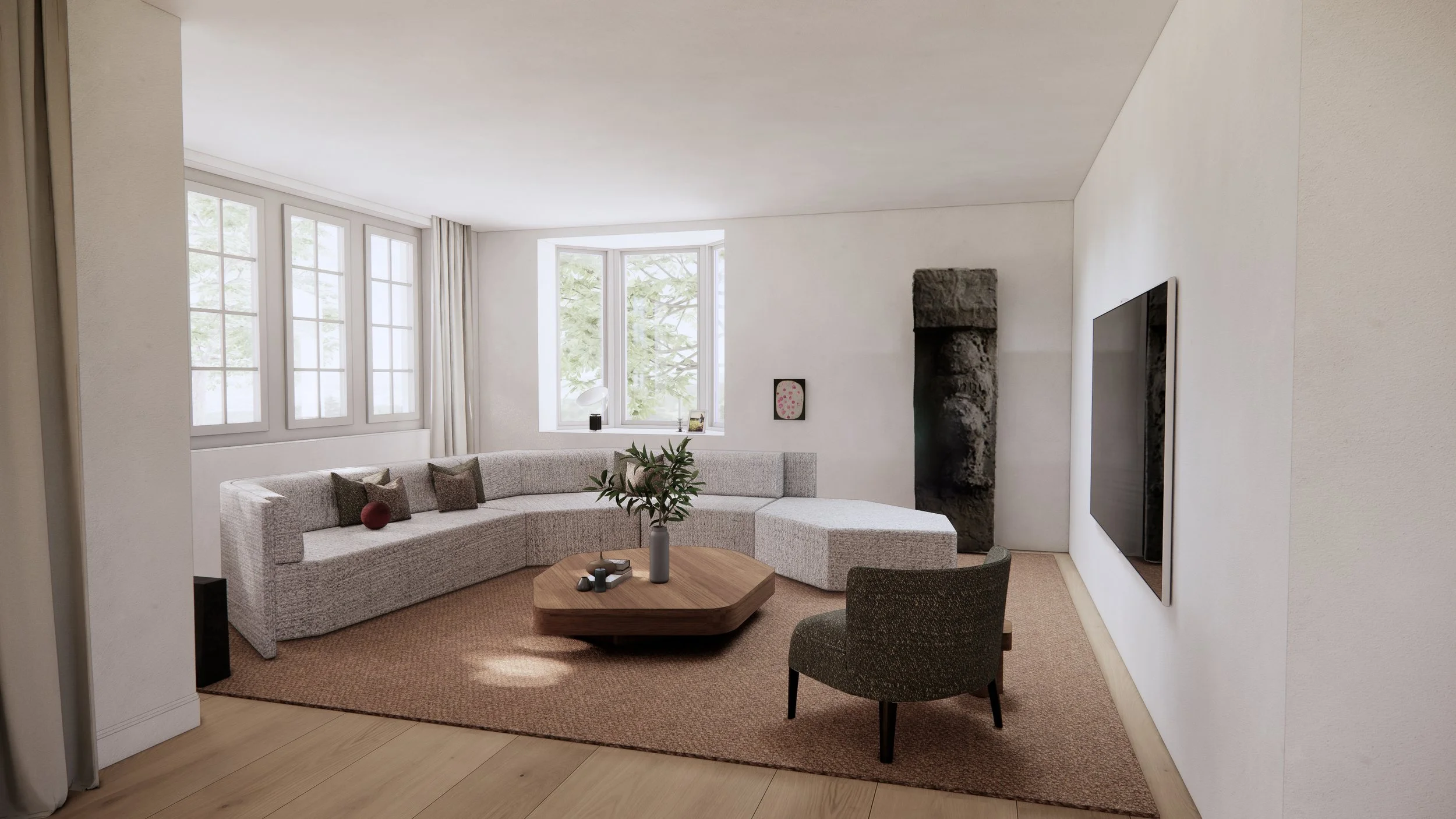 Living room with a beige sectional sofa, a round wooden coffee table, a gray armchair, a flat-screen TV on the white wall, a stone fireplace, and large windows with white curtains, filled with natural light.