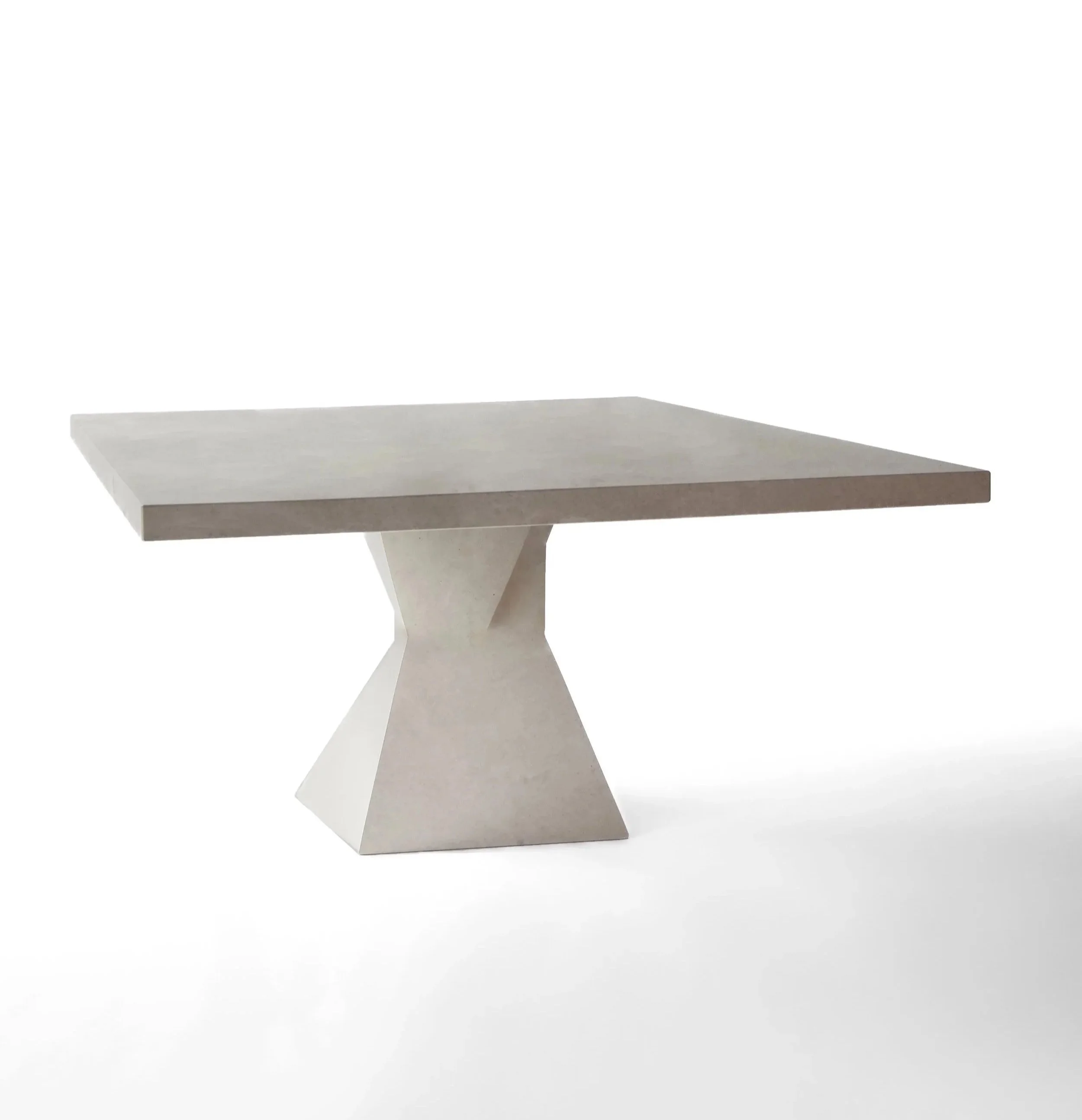 Modern square marble table with a geometric pillar base on a white background.
